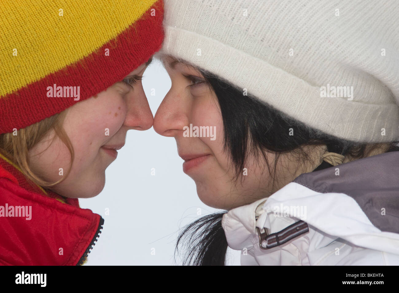 Two Cute girls Together sharing a secret winter Sweden Stock Photo