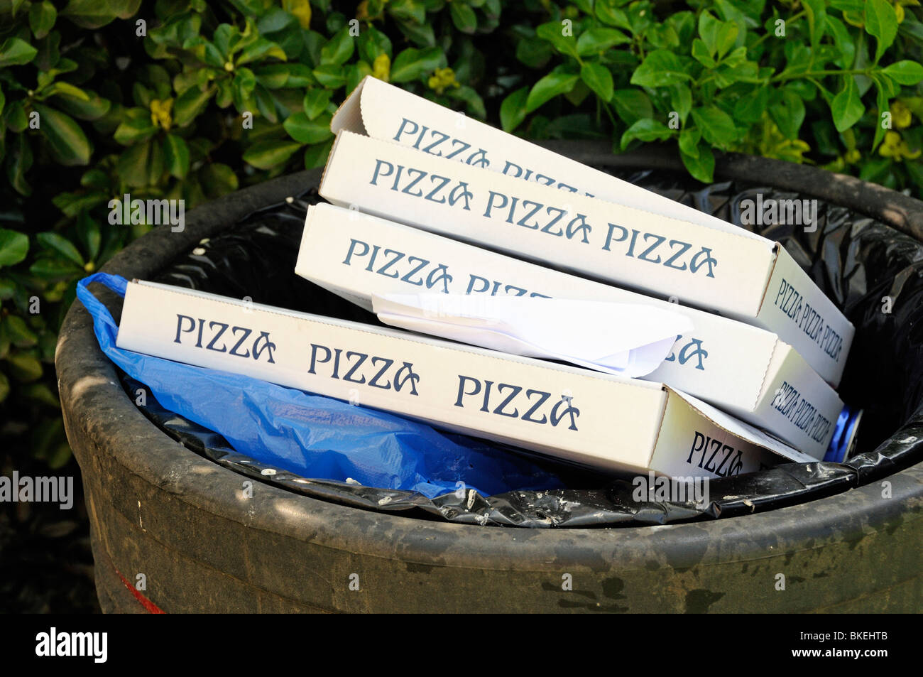 Pizza boxes in rubbish bin City of London England UK Stock Photo