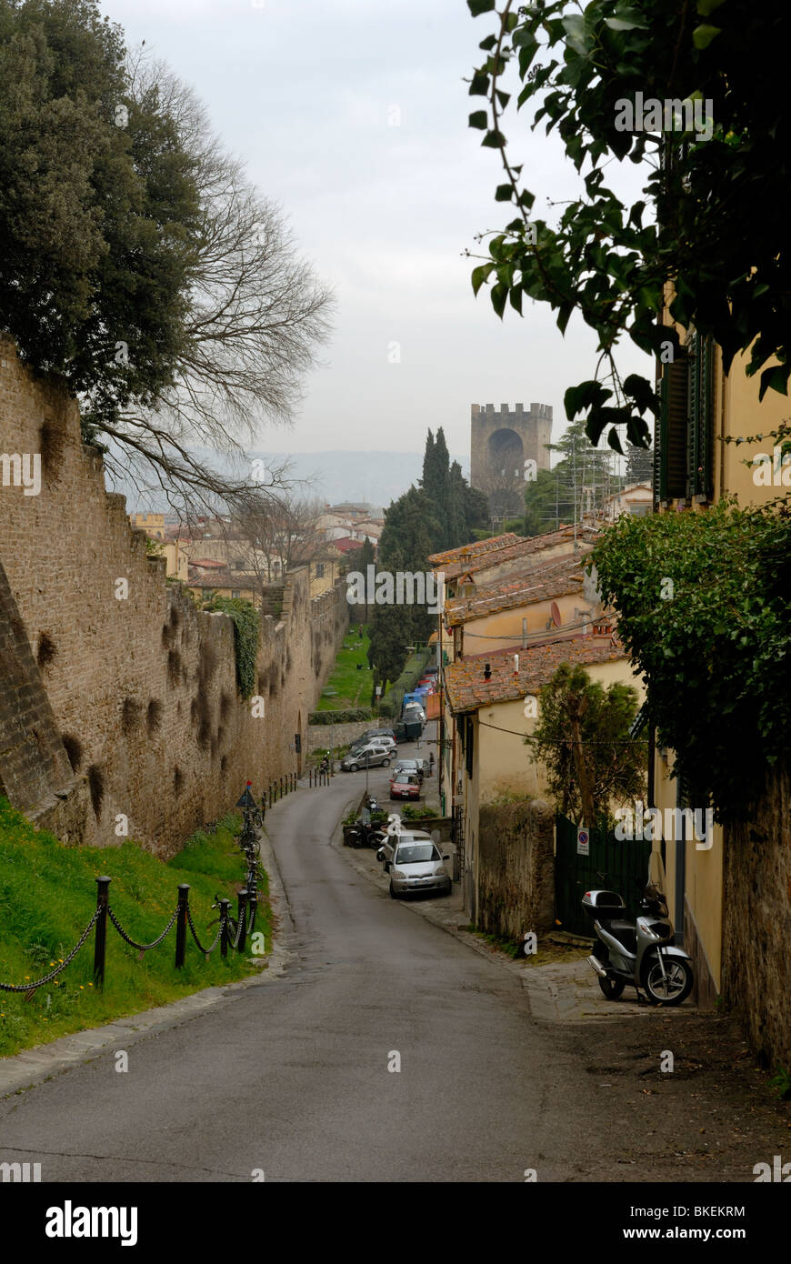 A spectacular misty spring morning view downhill along Via di Belvedery to Porta San Miniato. On the left is the city walls, ... Stock Photo