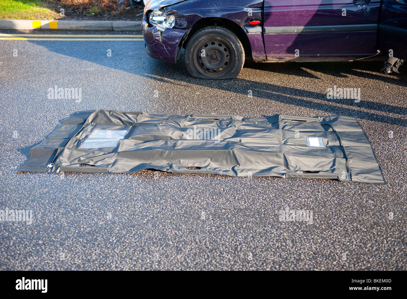Body bag at scene of car crash - simulation Stock Photo