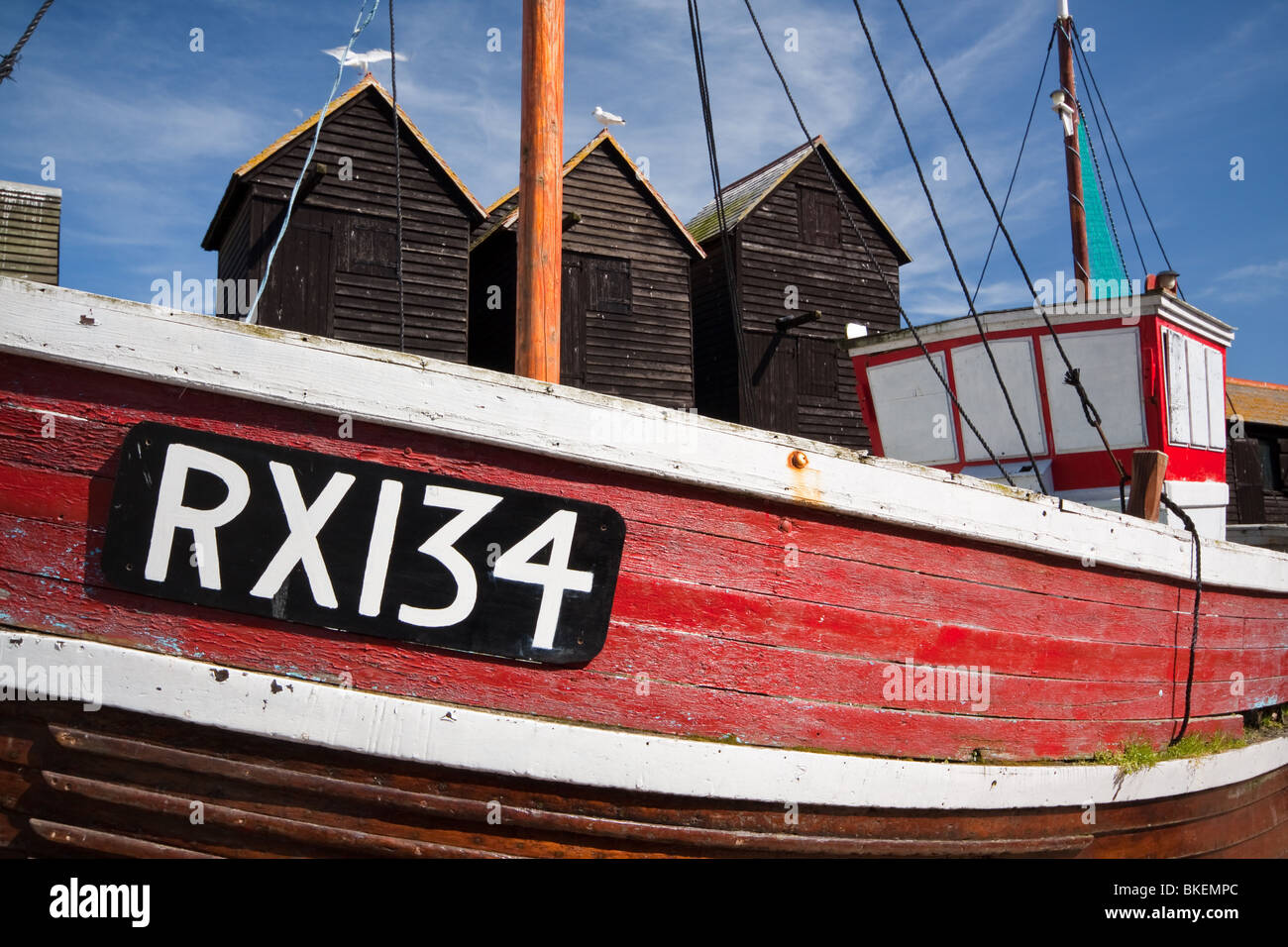 https://c8.alamy.com/comp/BKEMPC/fishing-boat-and-traditional-net-huts-hastings-east-sussex-BKEMPC.jpg