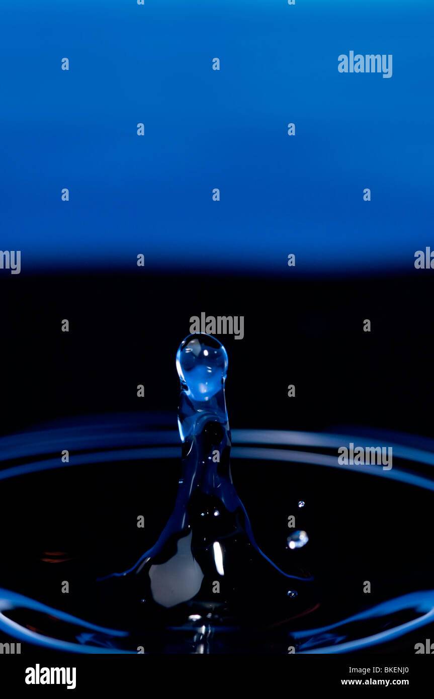 Water drop having hit the water surface causes a shape to rise and a