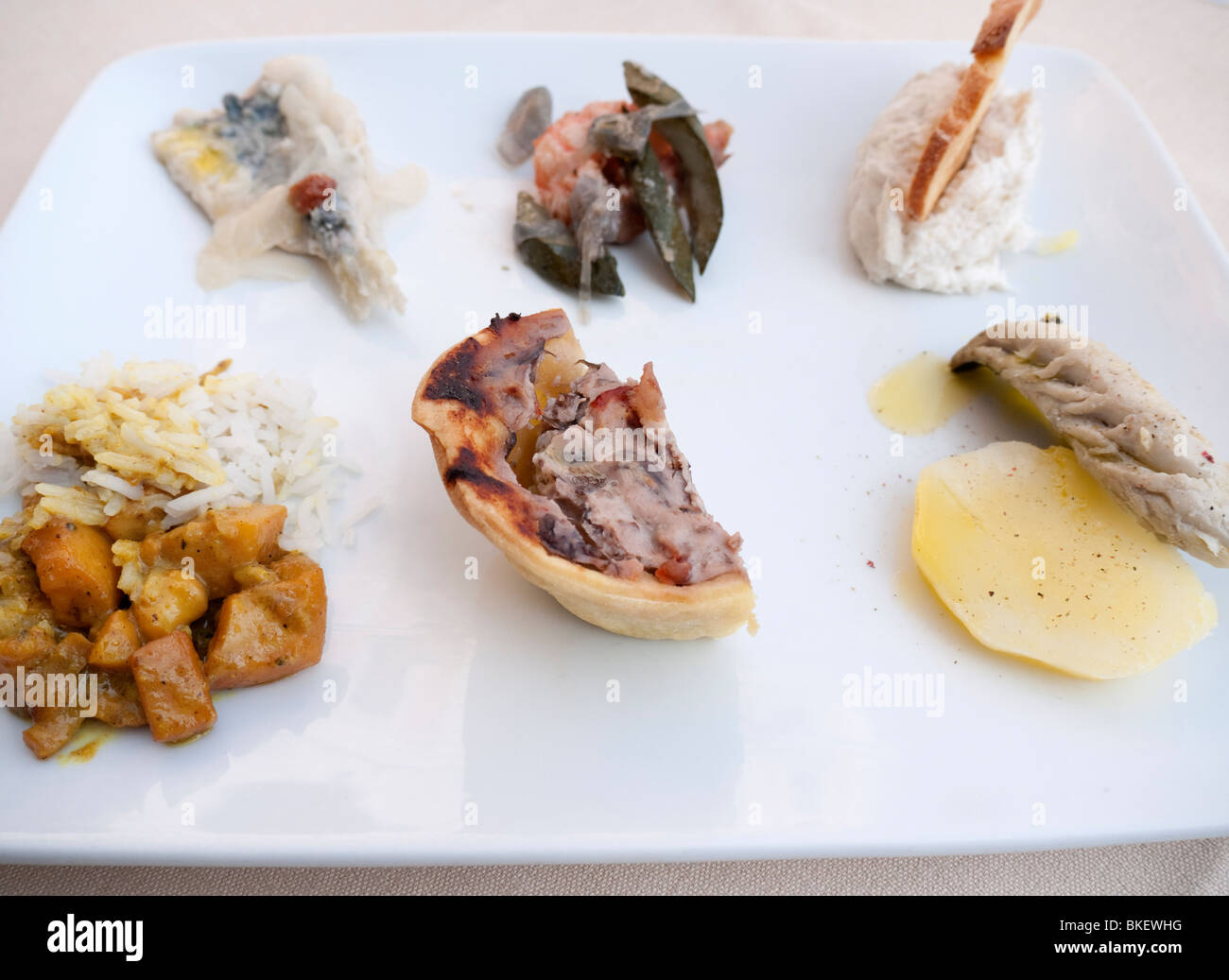 Detail of plate of traditional seafood Cicheti tapas  snacks at Osterie in Venice Italy Stock Photo