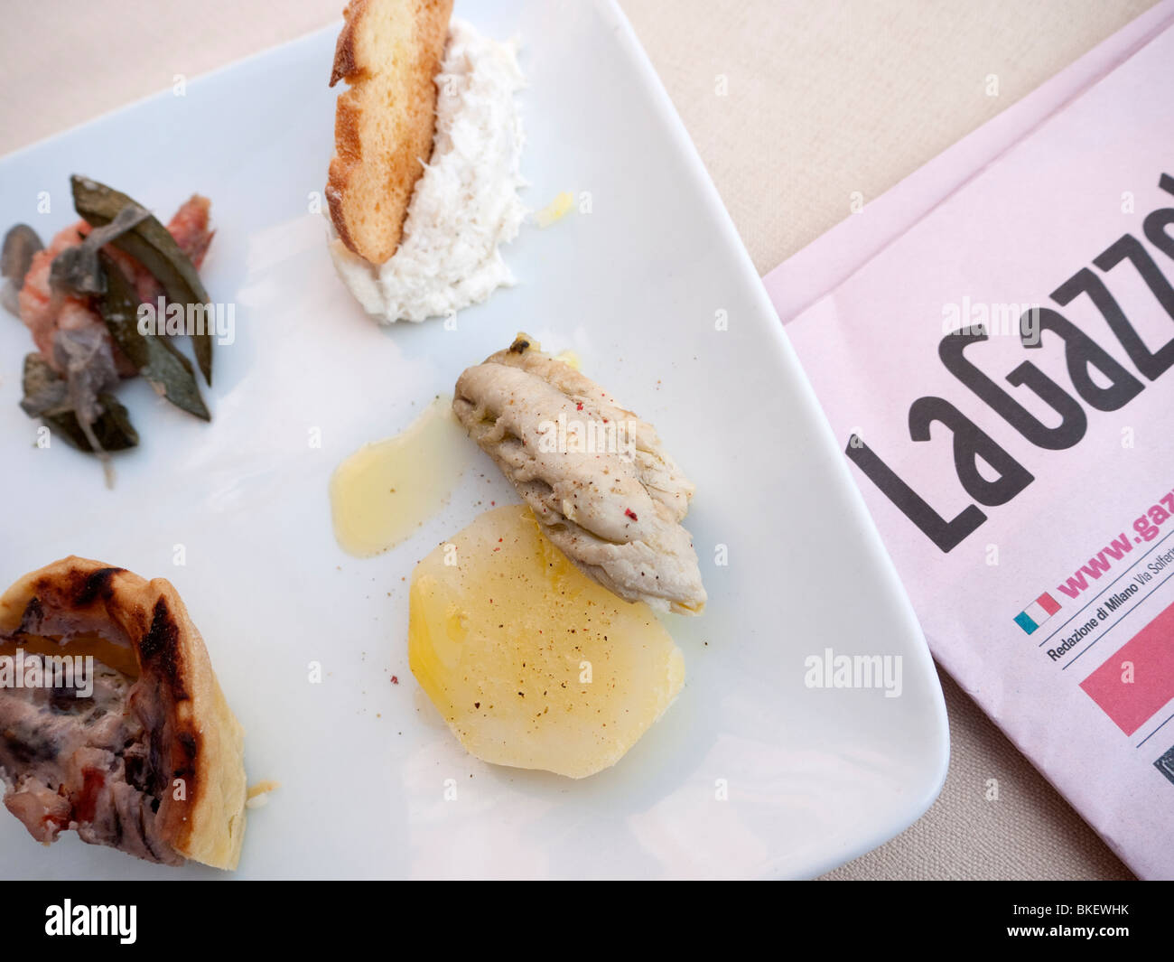 Detail of plate of traditional seafood Cicheti tapas  snacks at Osterie in Venice Italy Stock Photo