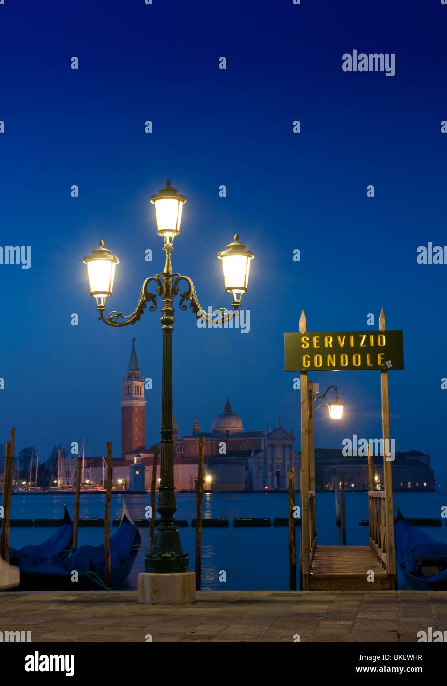 Gondola moorings at night before dawn beside Grand Canal at San Marco in Venice Italy Stock Photo