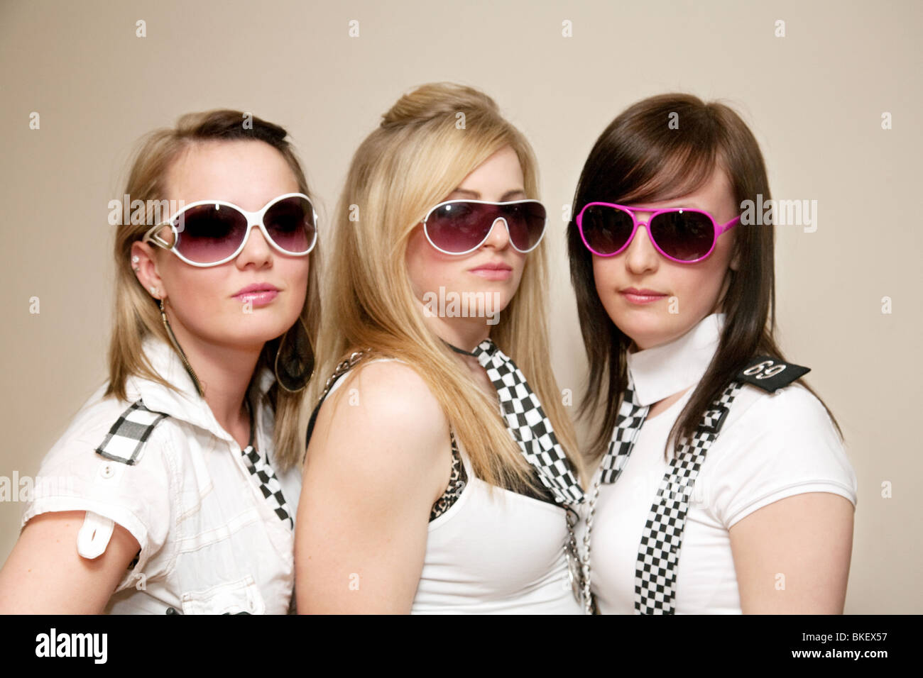 Teenage girls dressed up to go to a cops and robbers fancy dress party, UK Stock Photo