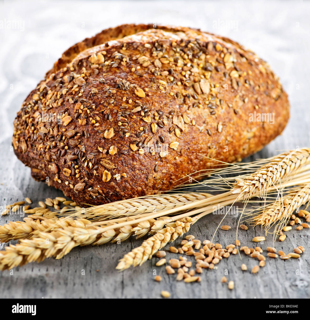 Loaf of fresh baked multigrain bread with grain ears Stock Photo