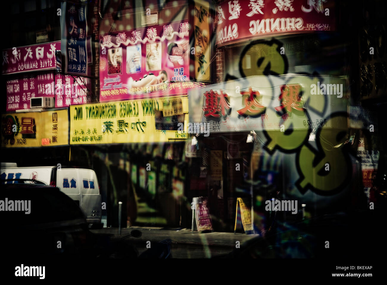 A shop window reflecting Chinese shop signs on 40th Avenue, Chinatown, Flushing, New York, USA Stock Photo