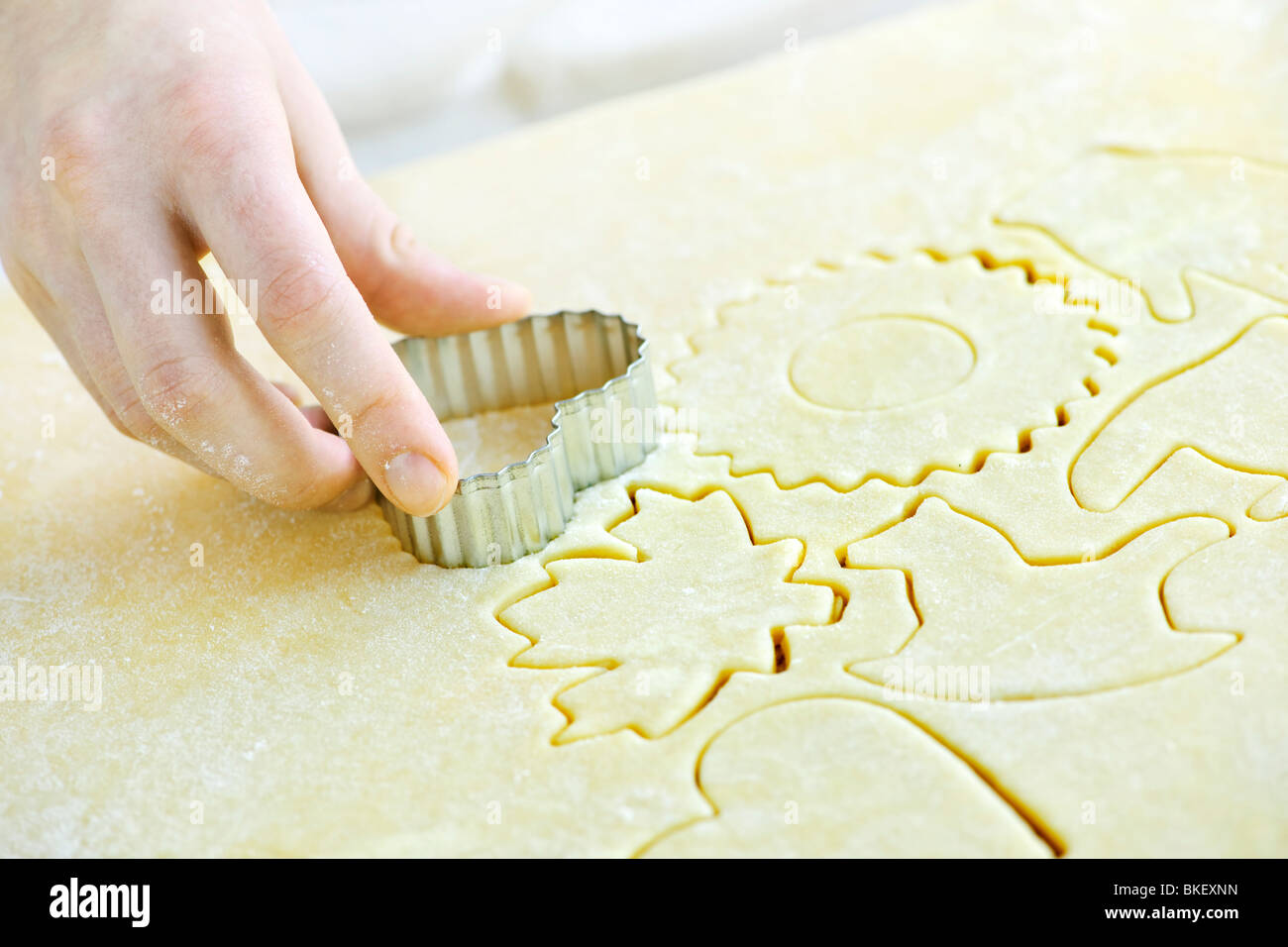 Cutting cookie shapes in rolled dough with cutter Stock Photo Alamy