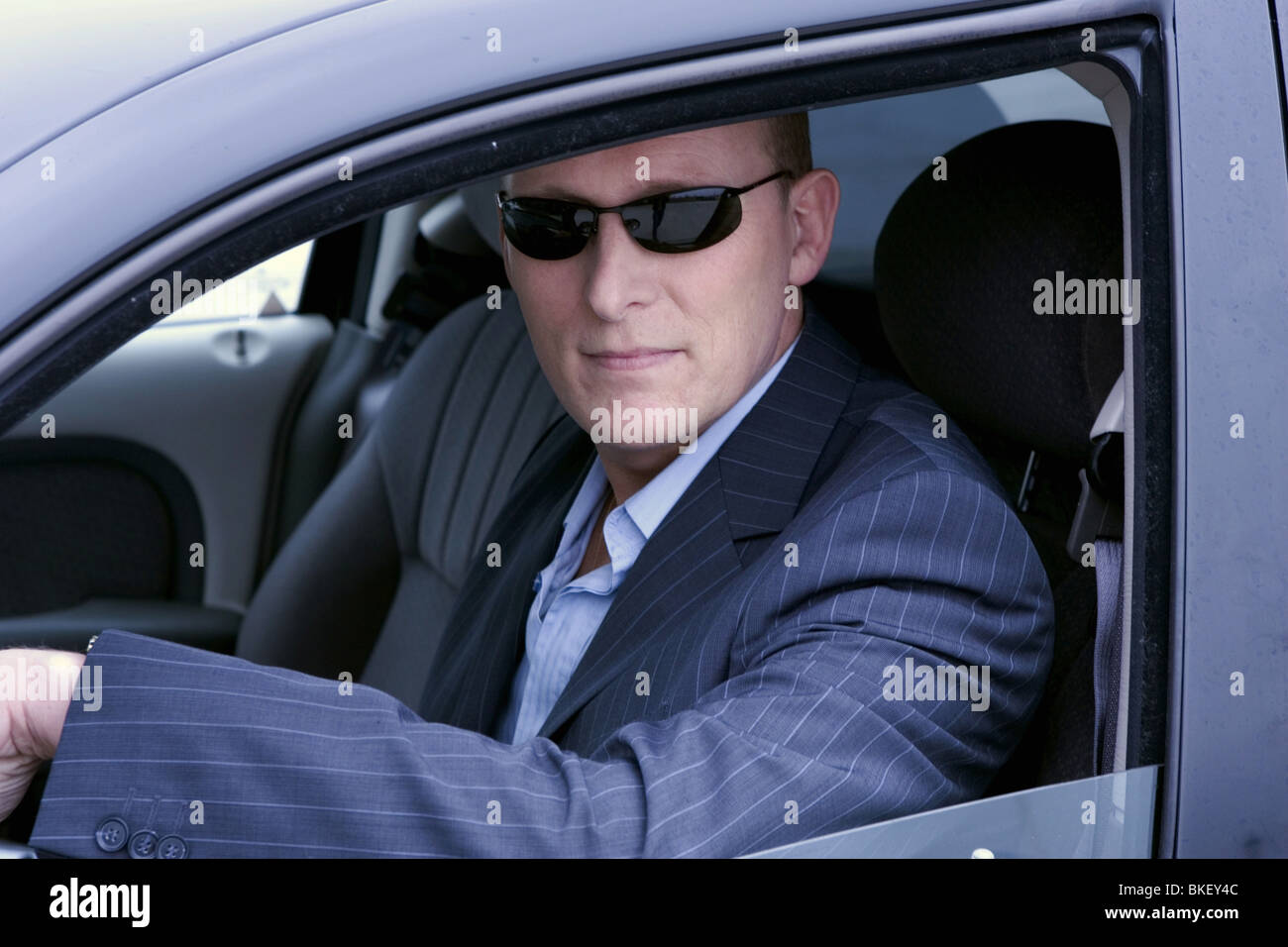 Man in car wearing sunglasses Stock Photo Alamy