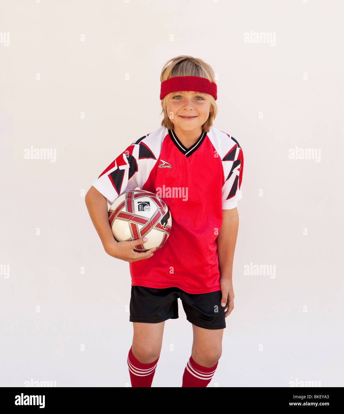 Boy with soccer ball in soccer uniform Stock Photo