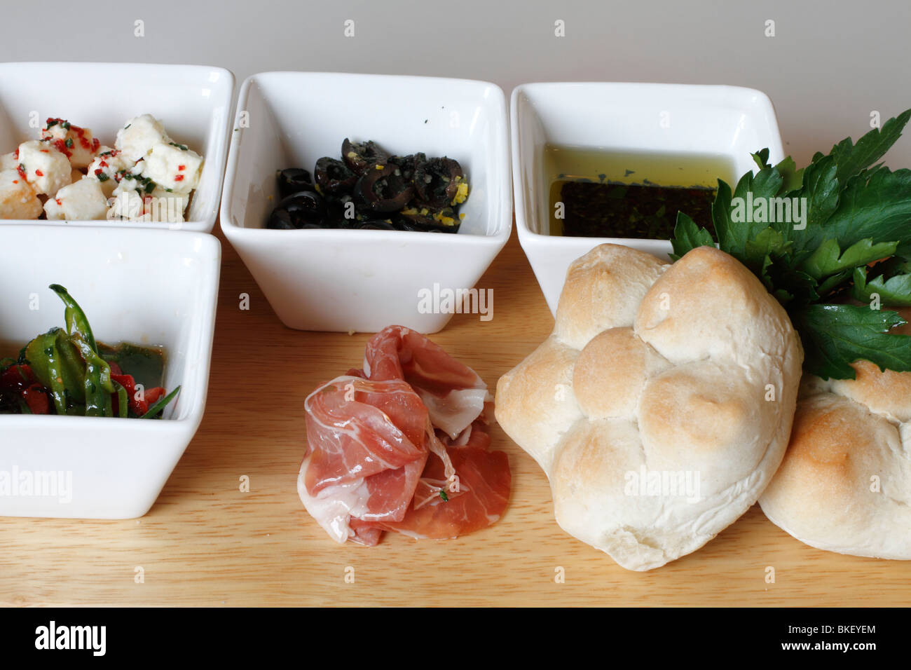 Mixed starter, feta (sheep) cheese, Olives in oil, olive oil dip, mixed shredded peppers, parma ham crusty bread rolls Wedding breakfast table Rufford wedding facilities, Rufford Mill Stock Photo