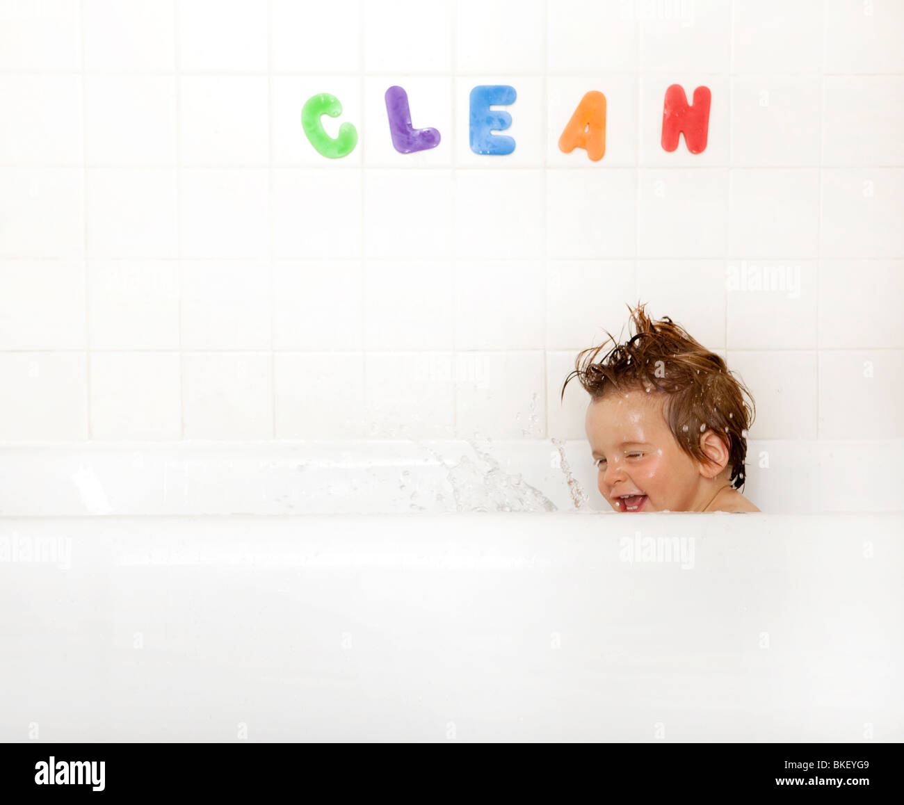 Boy splashing in bathtub Stock Photo Alamy