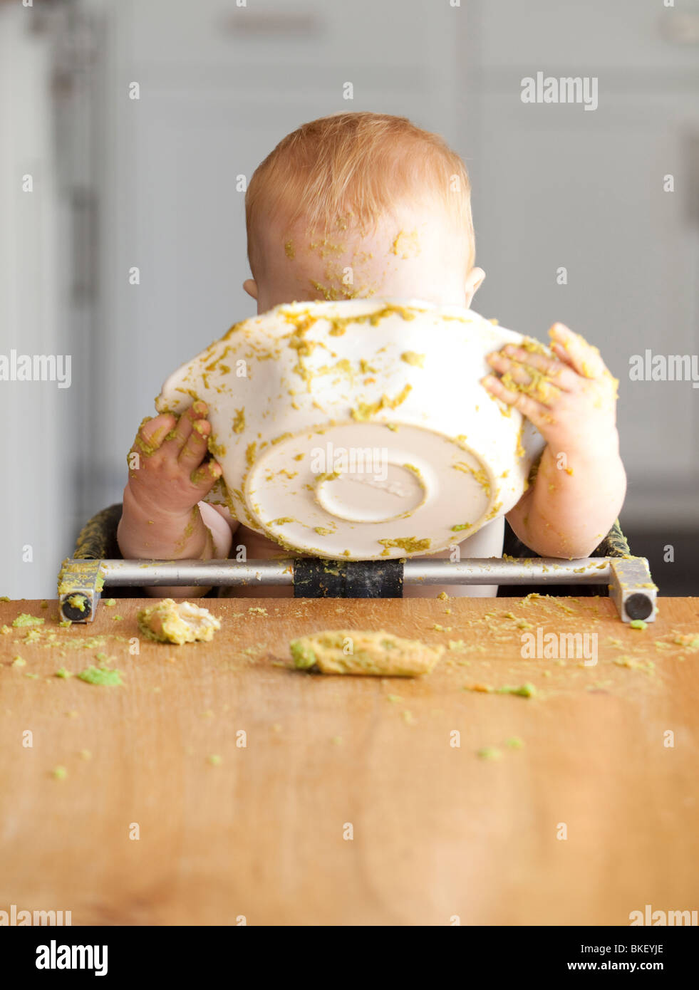 Baby eating bowl of peas Stock Photo Alamy