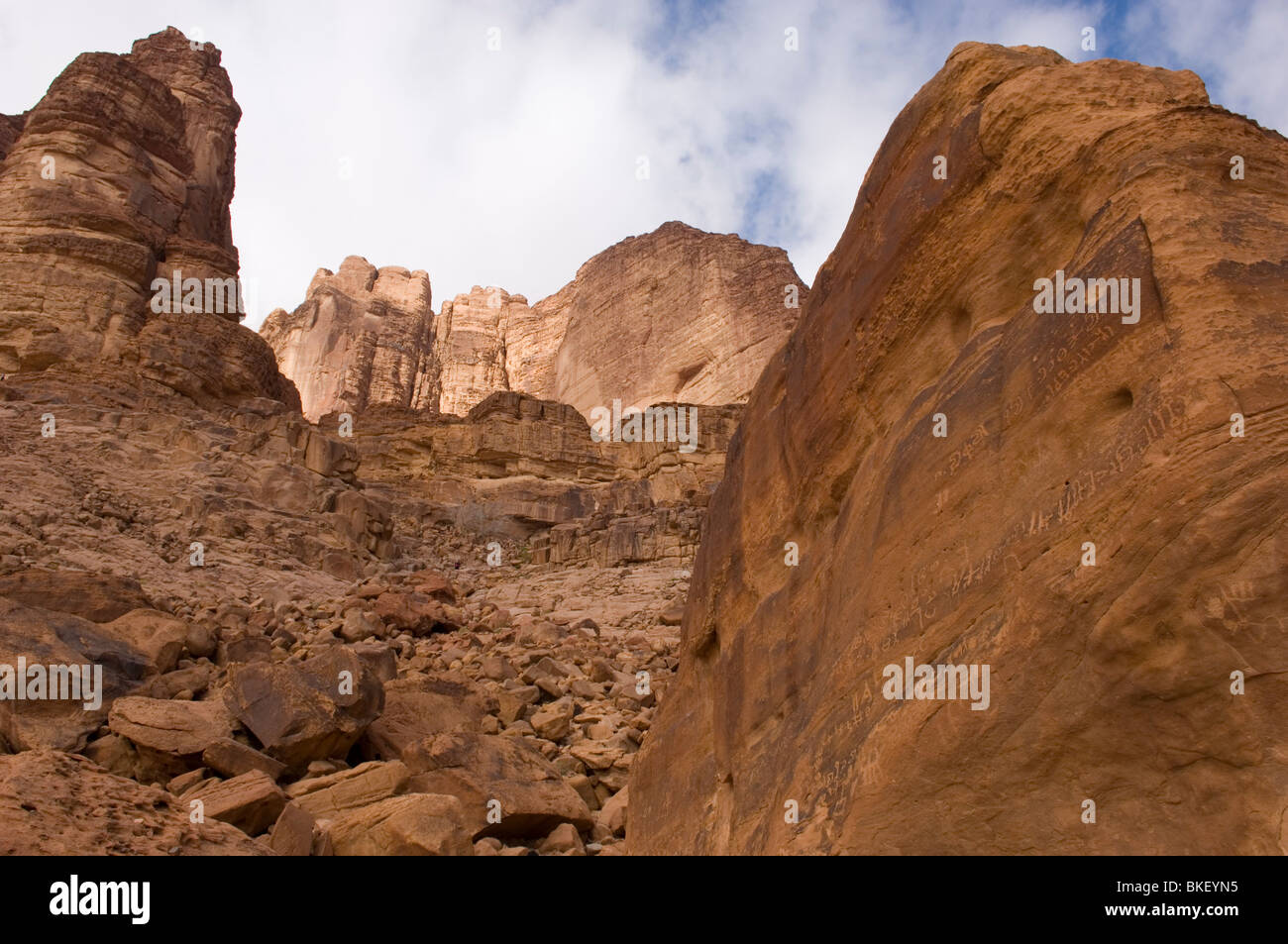 Rock with ancient Nabataean inscriptions near Lawrence's  Spring in the desert of Wadi Rum, Jordan Stock Photo