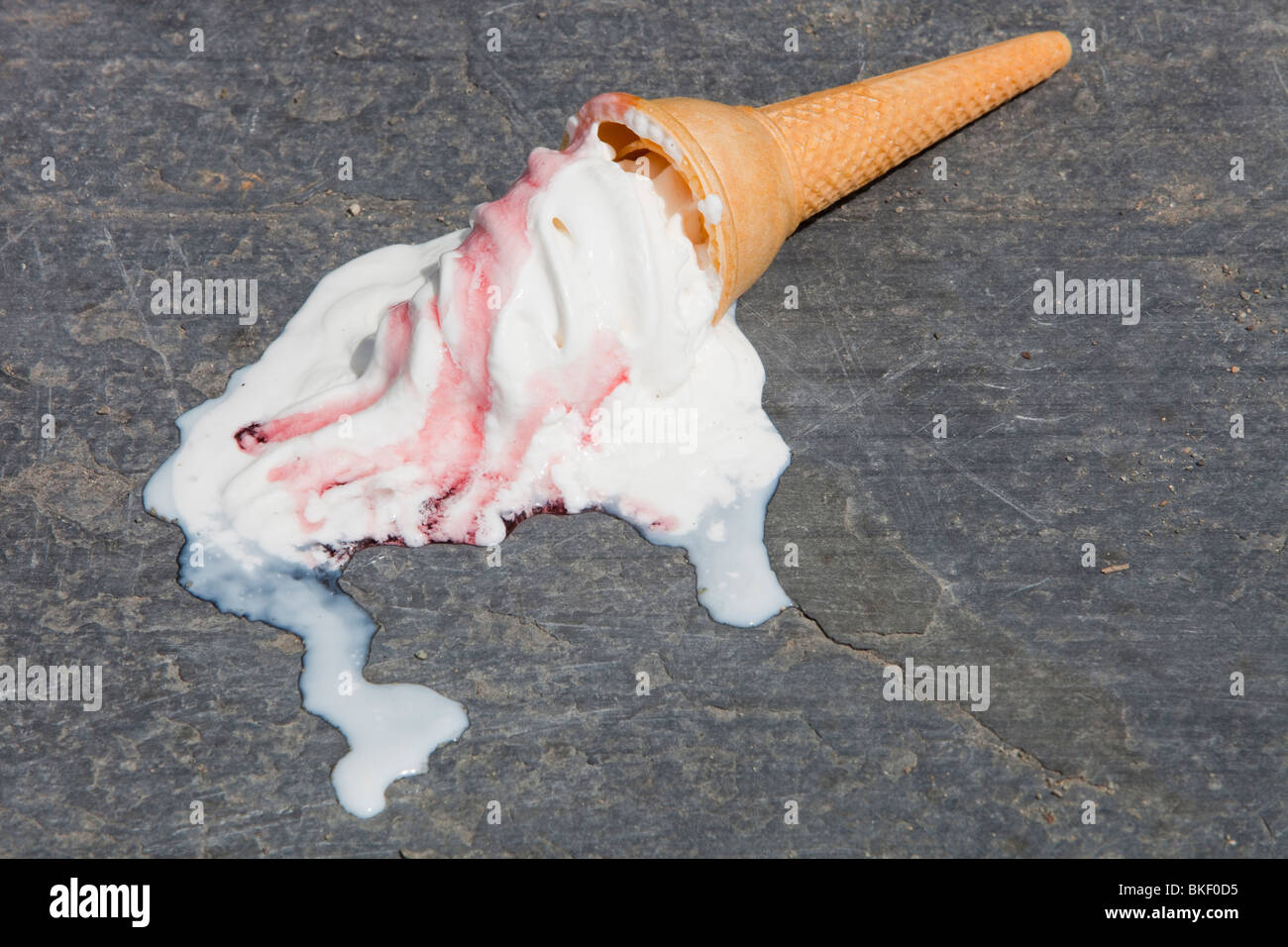 An ice cream melting on the shores of Lake Windermere, Cumbria UK during a summer heat wave. Stock Photo
