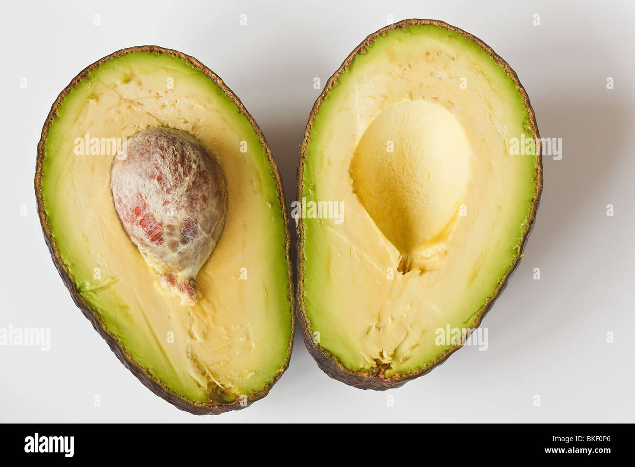 Avocado Cut In Half With The Seed In Stock Photo Alamy