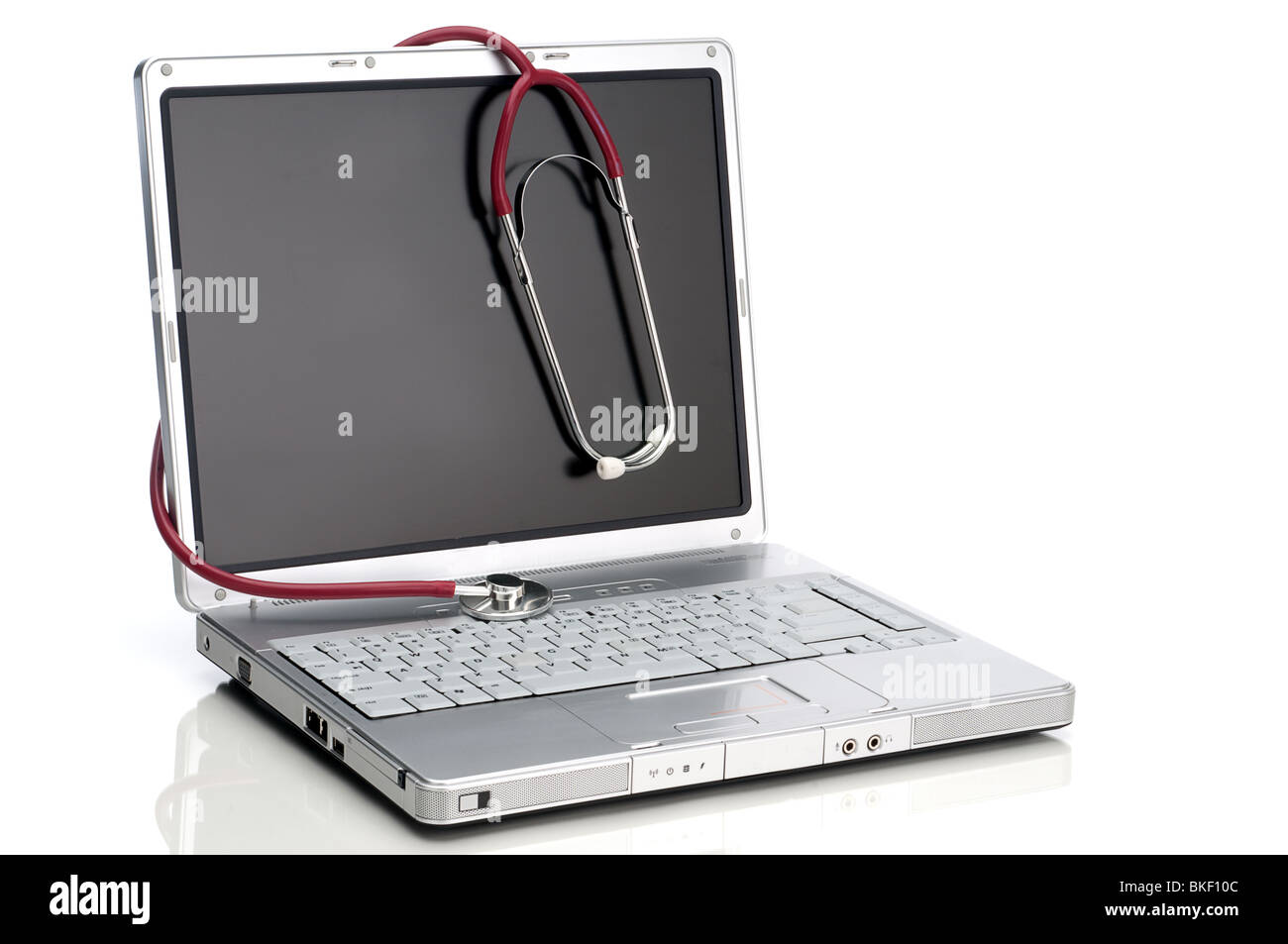 A horizontal image of a stethoscope on a computer on white Stock Photo