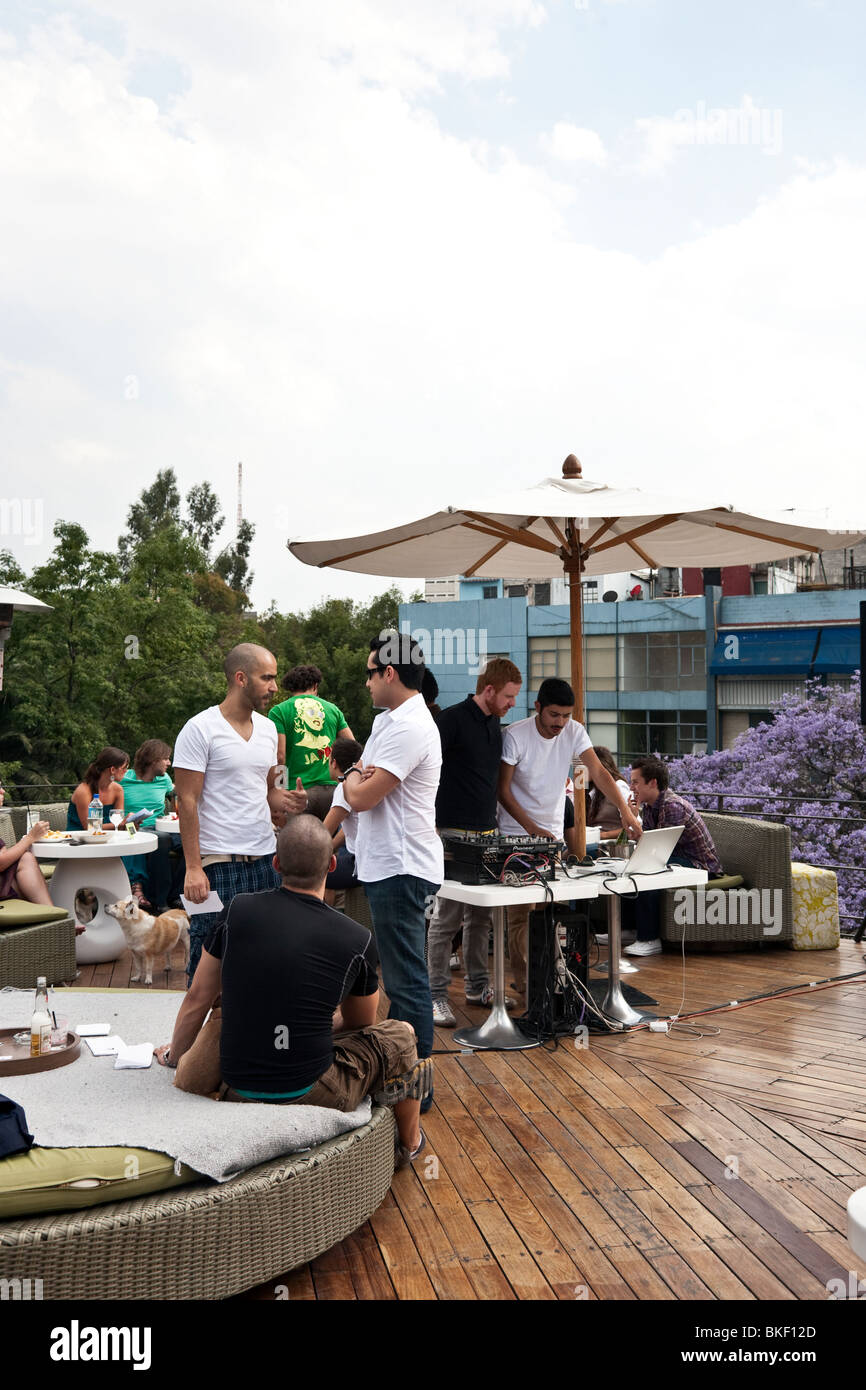 upscale young crowd of gay & straight Mexicans enjoys Sunday brunch scene at Hotel Condesa rooftop bar Condesa district Mexico Stock Photo