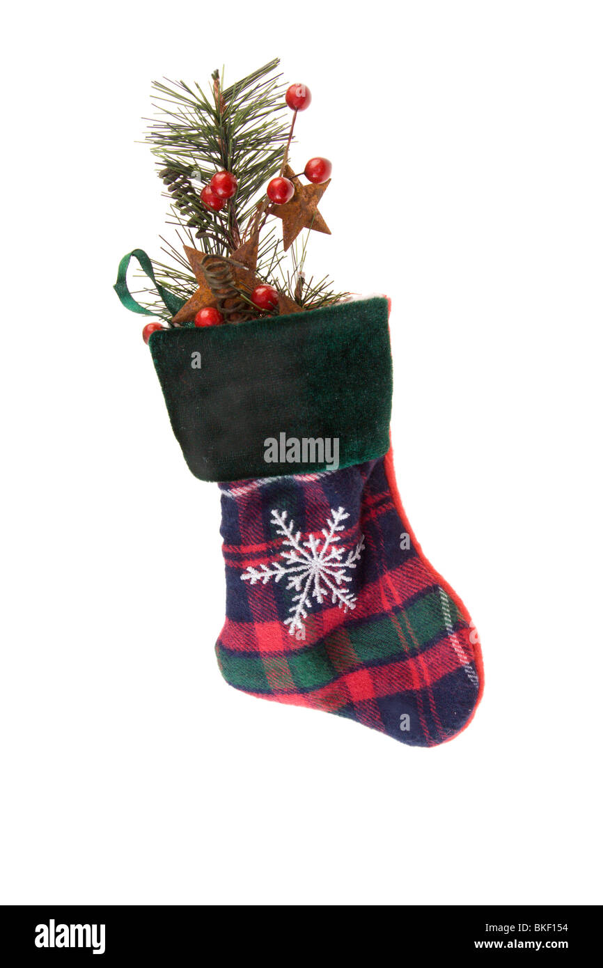 traditional plaid stocking with fir branch, star shapes, and red holly berries on white Stock Photo