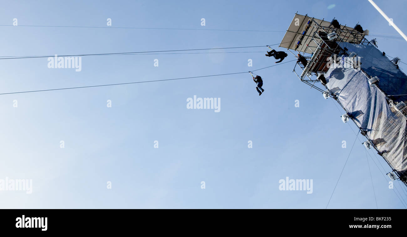 Two zippers jump off the top of the zip wire stretching across Robson Square as part of the