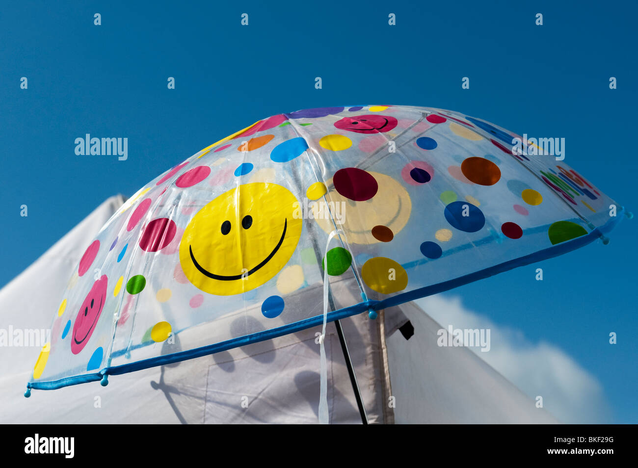 Colourful spotted smiley face childrens umbrella Stock Photo - Alamy