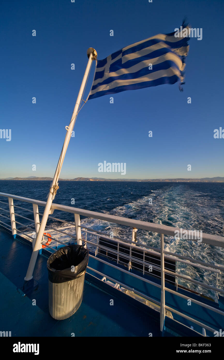 The Greek flag overlooking the Aegean Sea on a ferry ship Stock Photo
