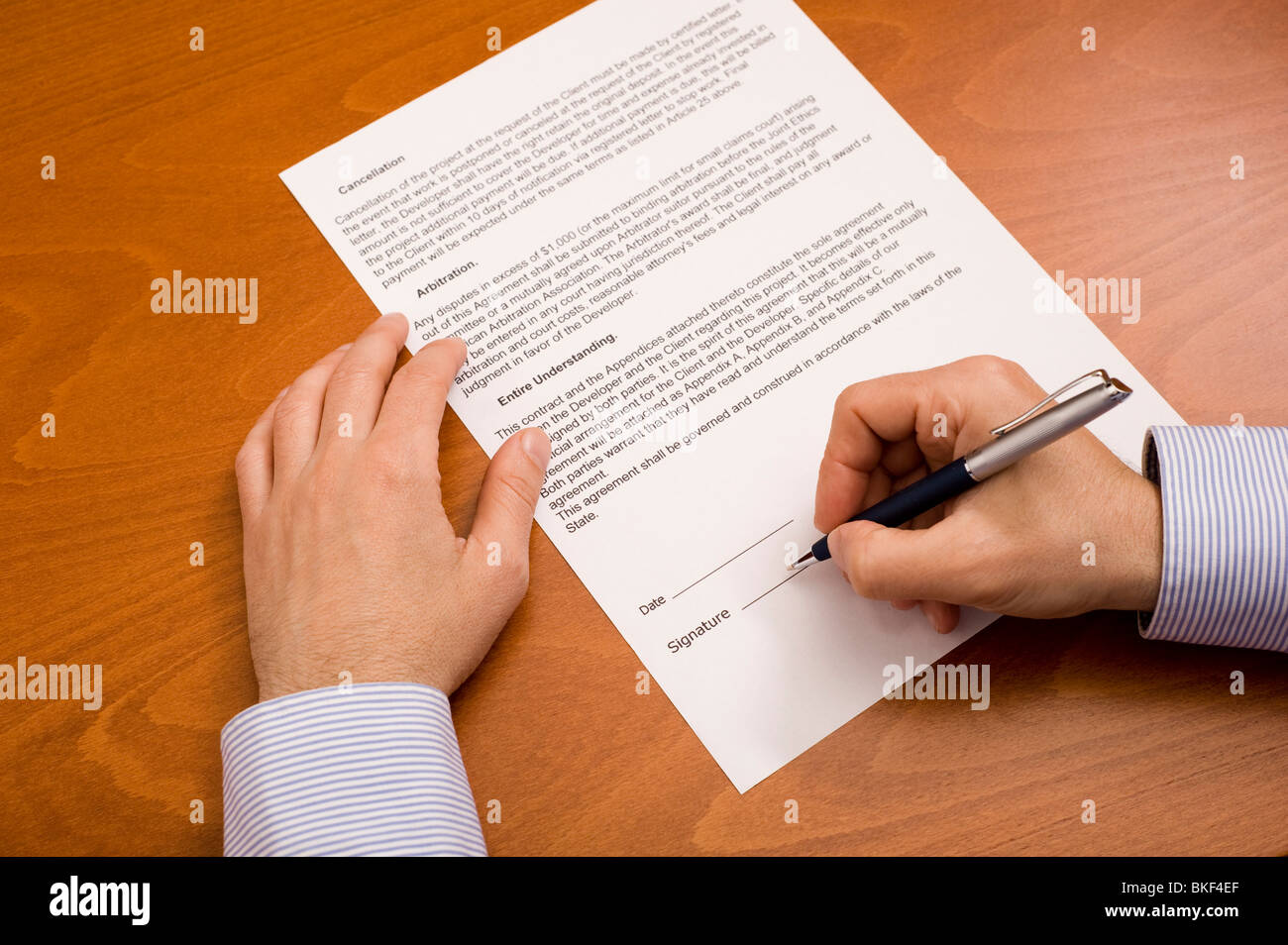 man signing a contract Stock Photo