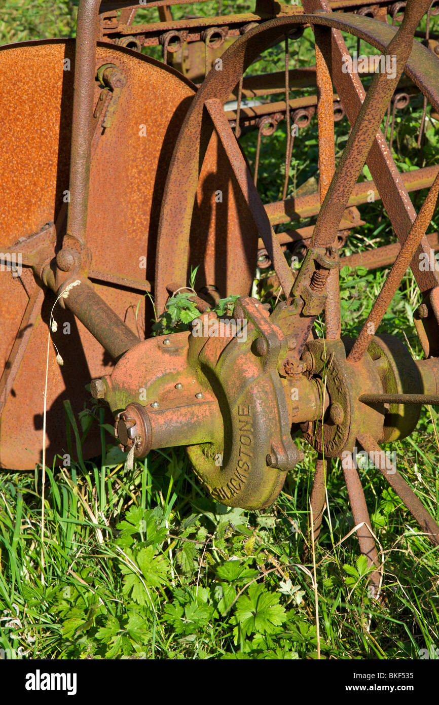 rusty farm machinery in corner of field. Stock Photo