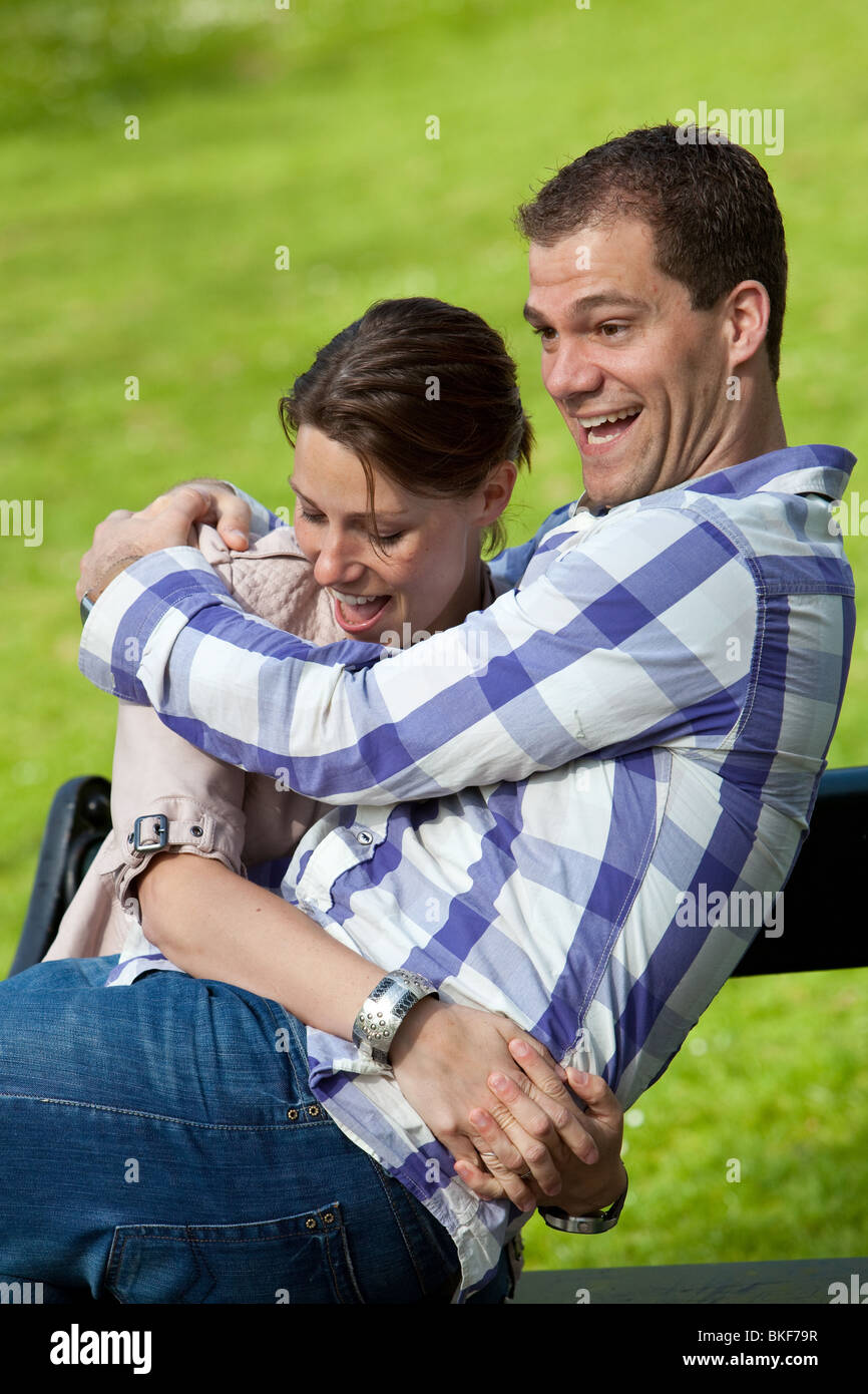 Attractive young couple having fun together in the park Stock Photo - Alamy