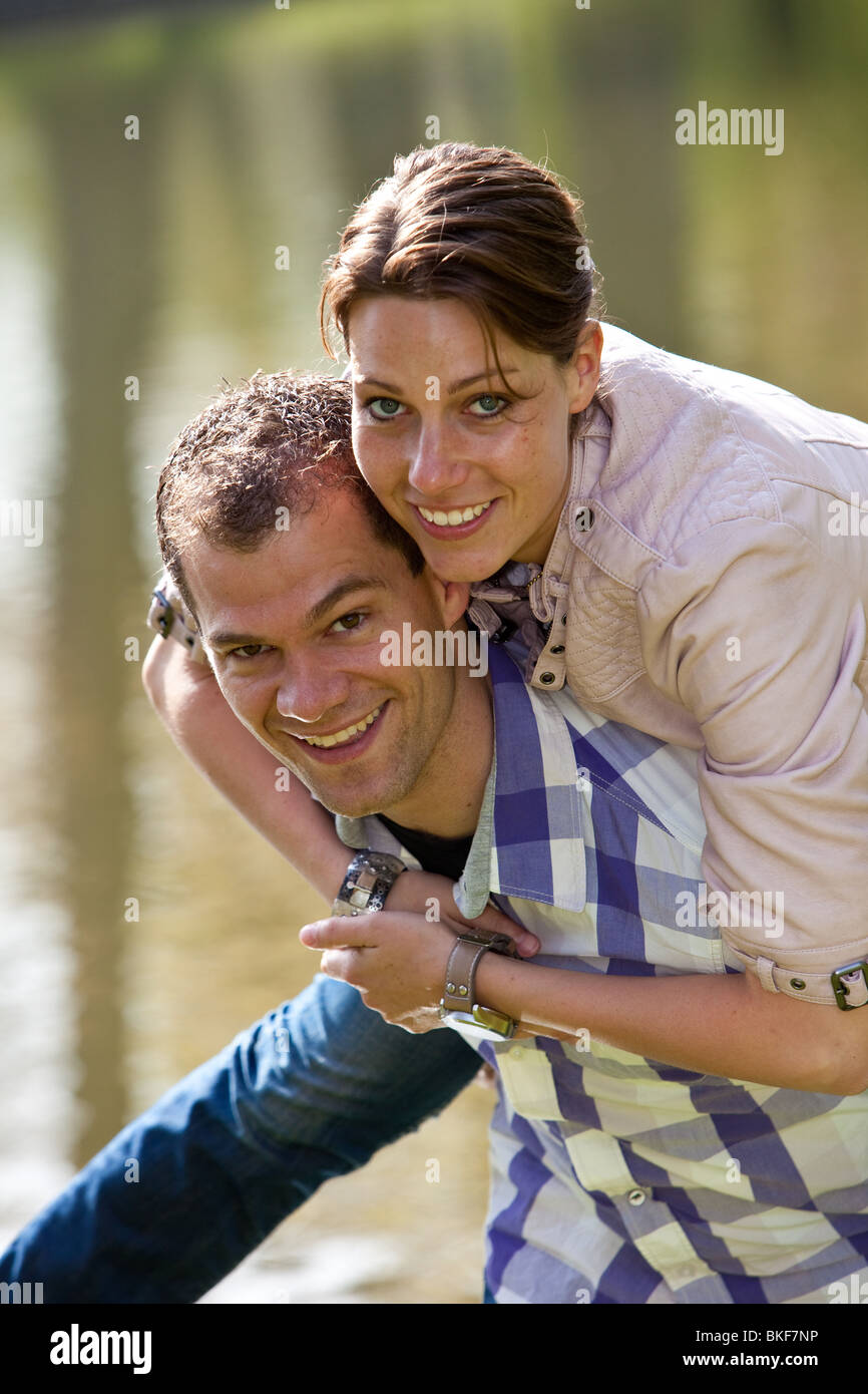 Cute couple outdoors having fun and doing a piggyback ride Stock Photo ...