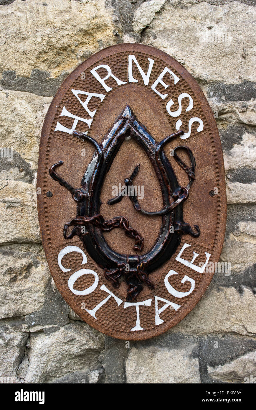 Unusual illustrative house sign showing a harness Stock Photo