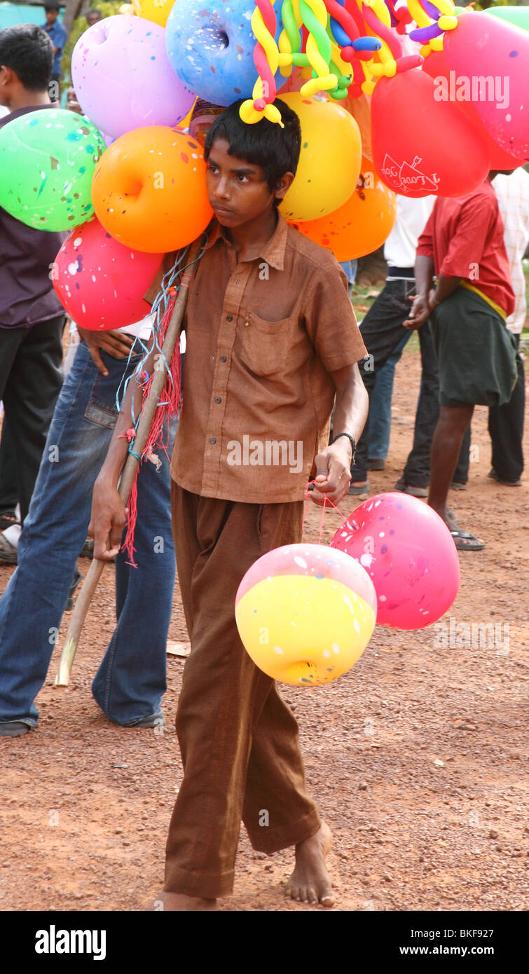 A barefoot balloon vendor at a Hindu festival in Varkala, Kerala Stock Photo