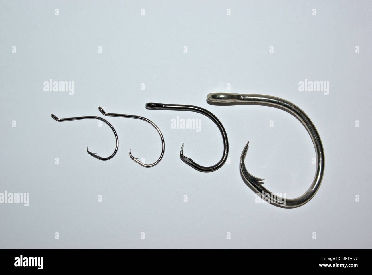 Barbed and barbless circle fishing hooks have curved points for