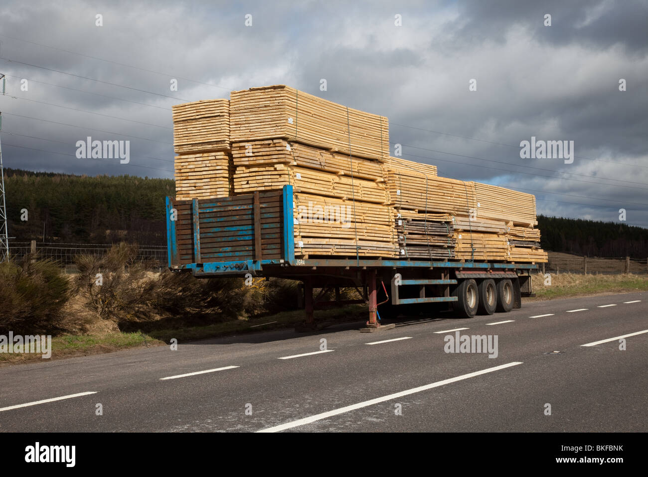 Parked Truck, Lorry Trailer in lay-by stacked with machined planks of Timber, Aviemore, Scotland, UK Stock Photo
