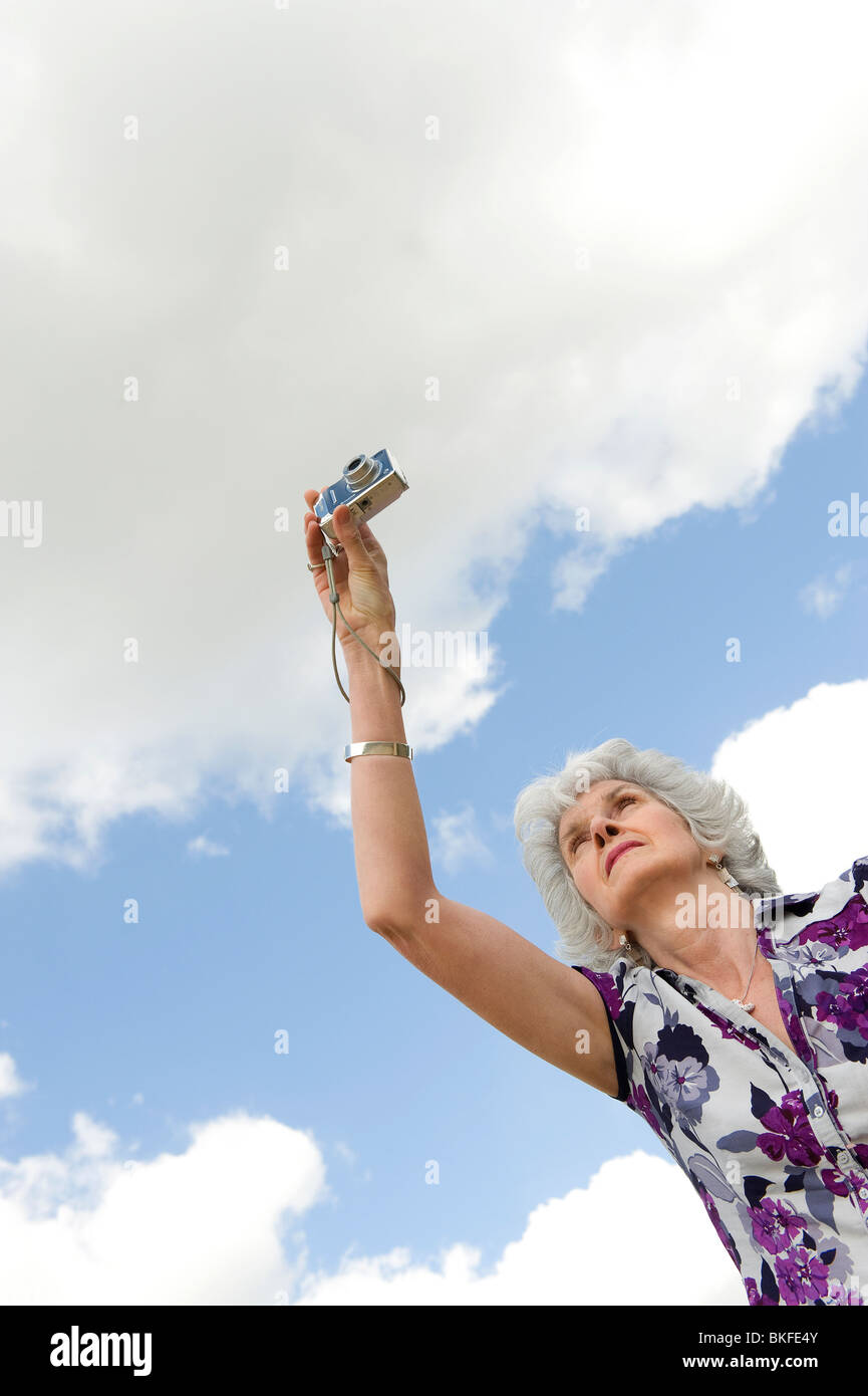 mature female taking photograph Stock Photo