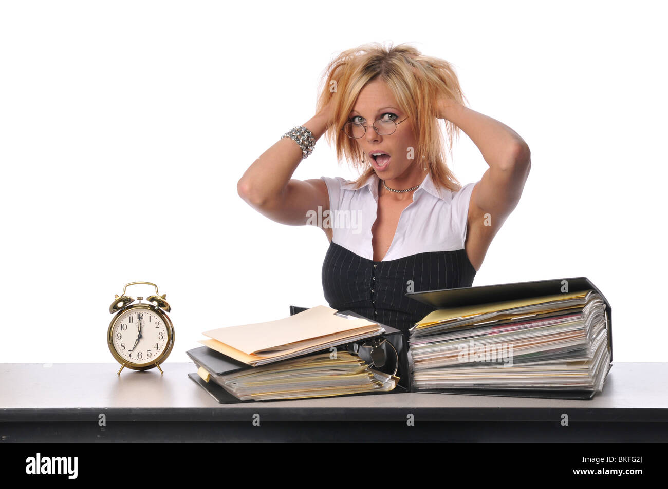 Young office worker with files and clock isolated on white Stock Photo