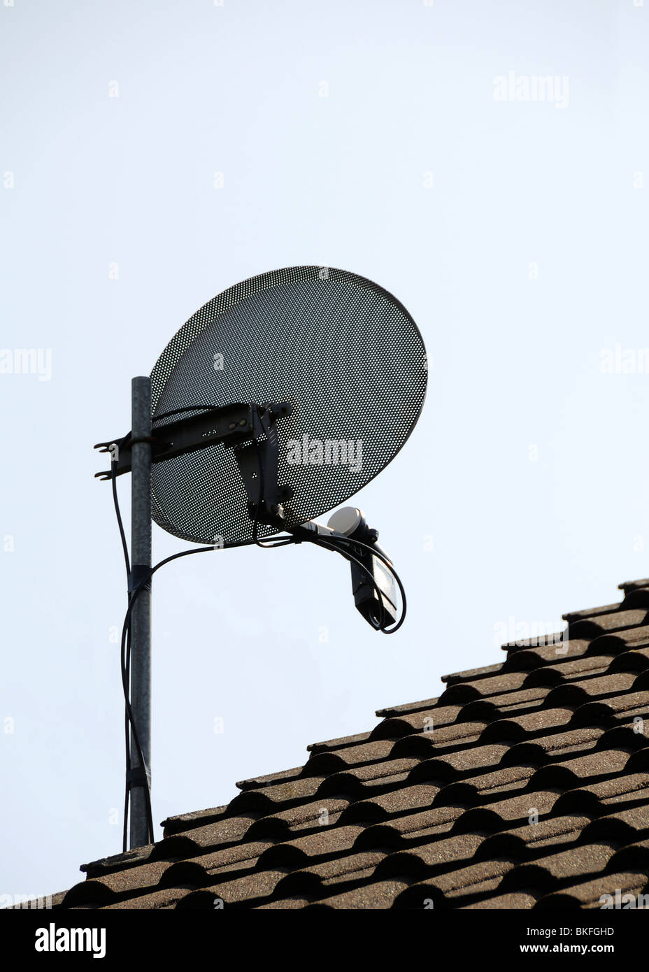 sky satellite television dish on roof Stock Photo