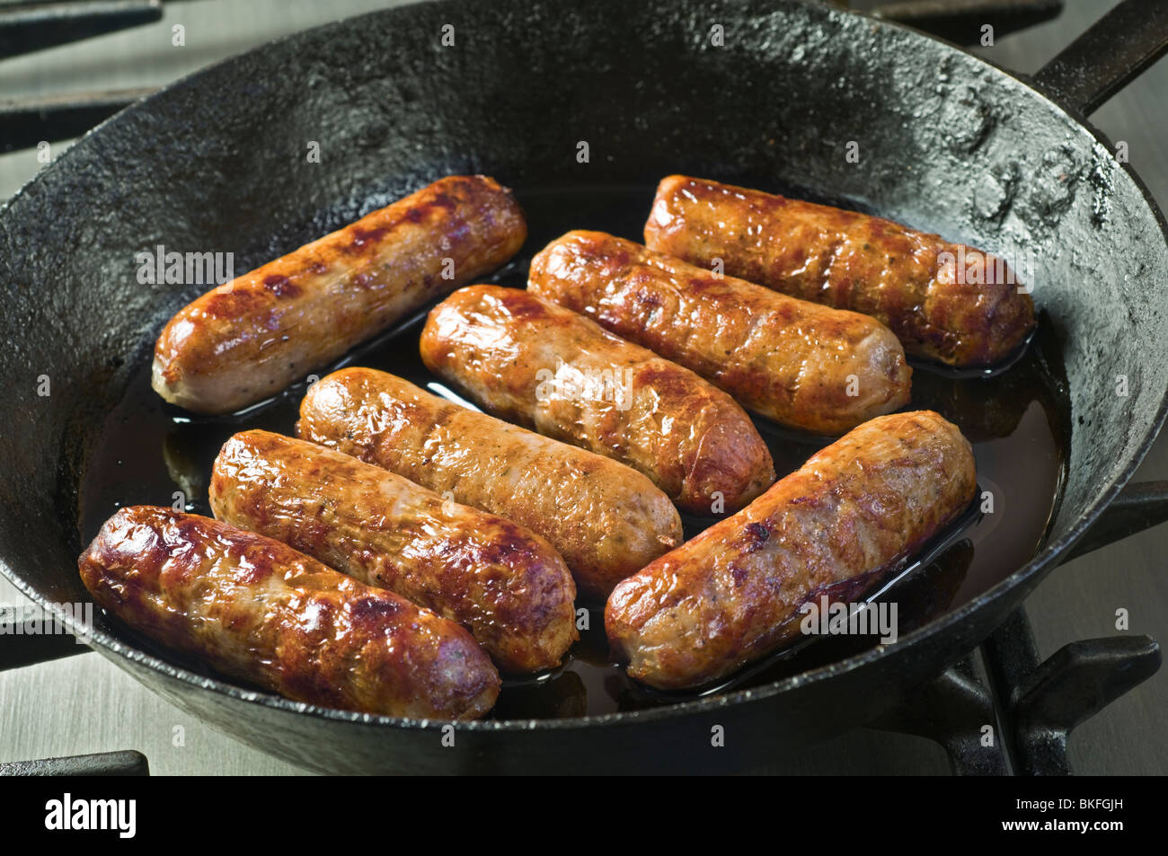 Sausages in frying pan Stock Photo Alamy
