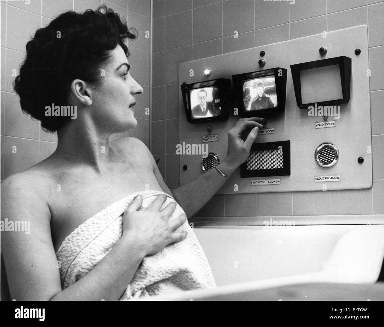 broadcast, television, woman in bathtube with small TV screens, circa 1960s, 60s, 20th century, historic, historical, monitoring system, safety system, security system, safety systems, security systems, mini television set, sets, bath, bathing, bath, bathtub, bath tub, bath tubs, towel, towels, people, women, female, Stock Photo