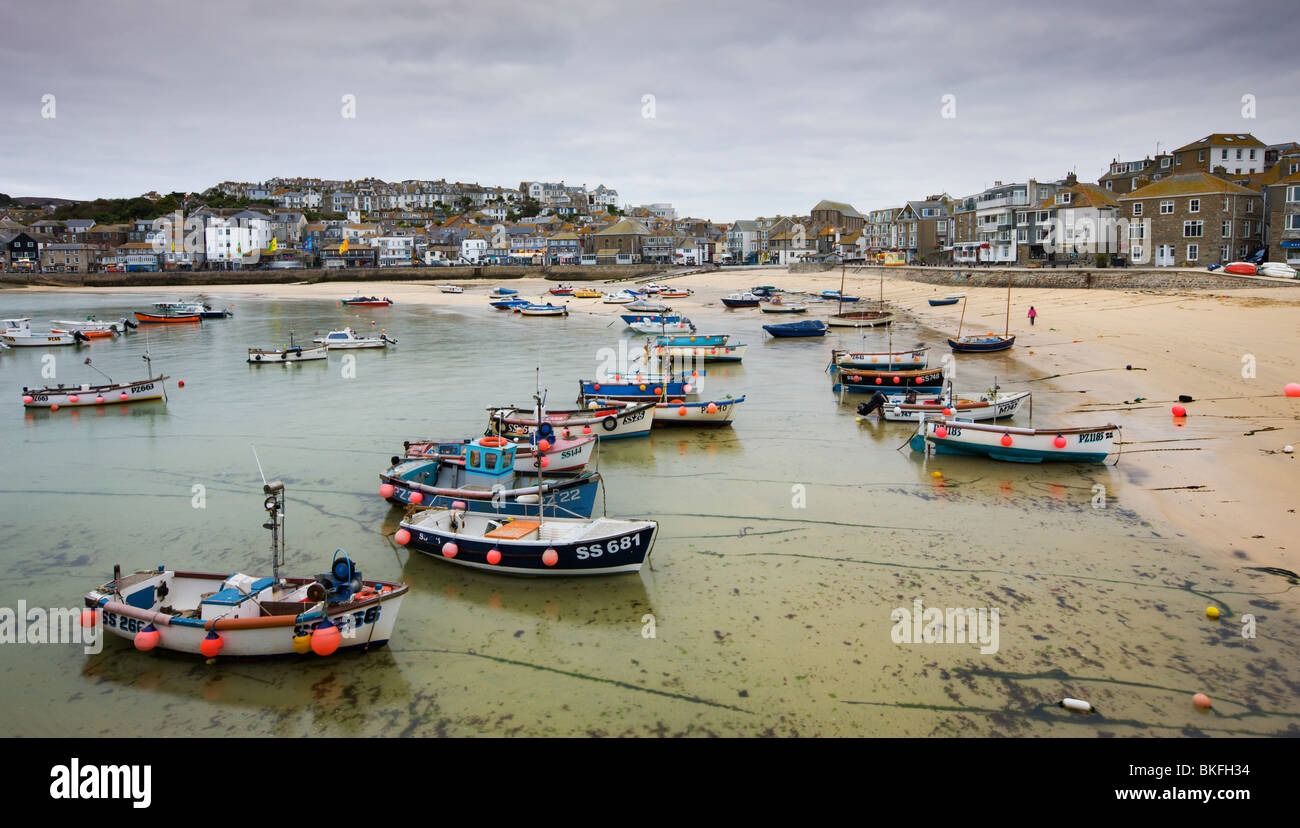 Fishing boats moored near the beach in St Ives harbour, Cornwall, England. Autumn (October) 2009 Stock Photo