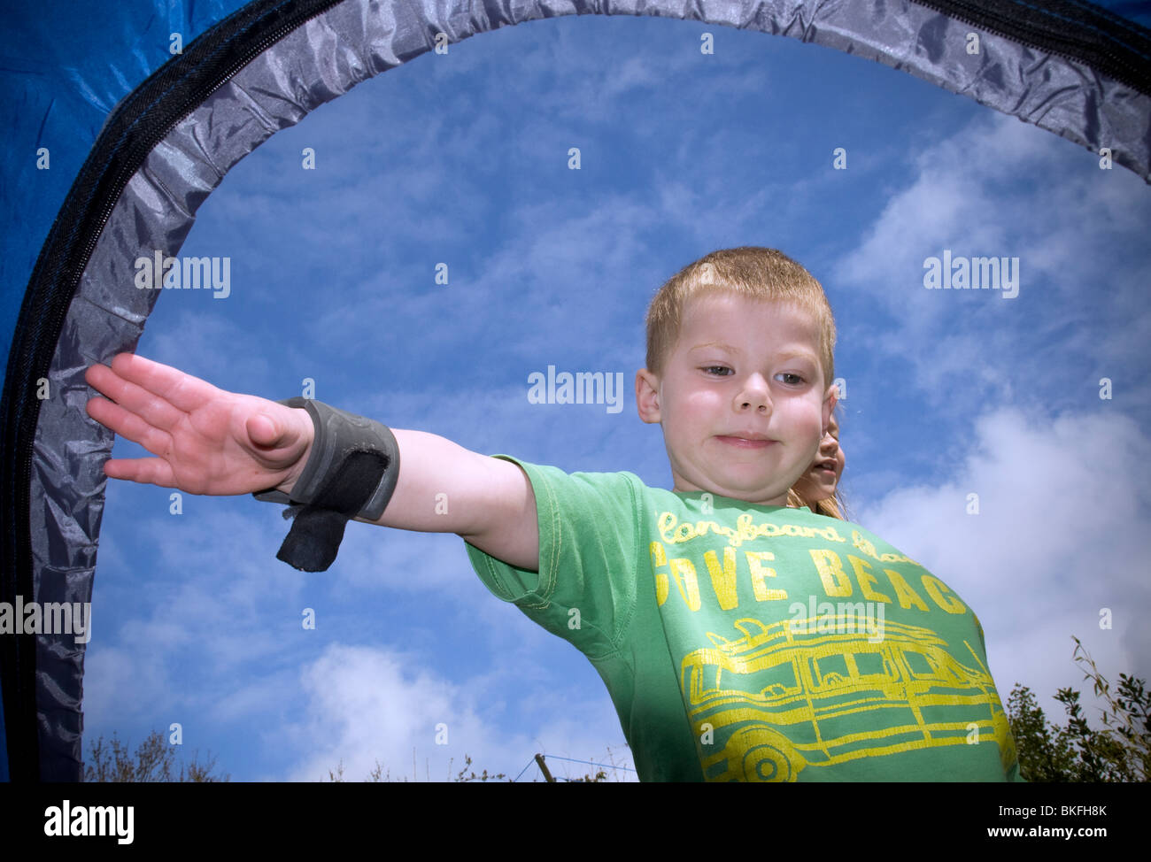 Five year old boy camping blue skies hires stock photography and