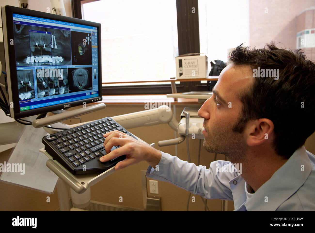 Periodontist looking at digital x-rays. Stock Photo