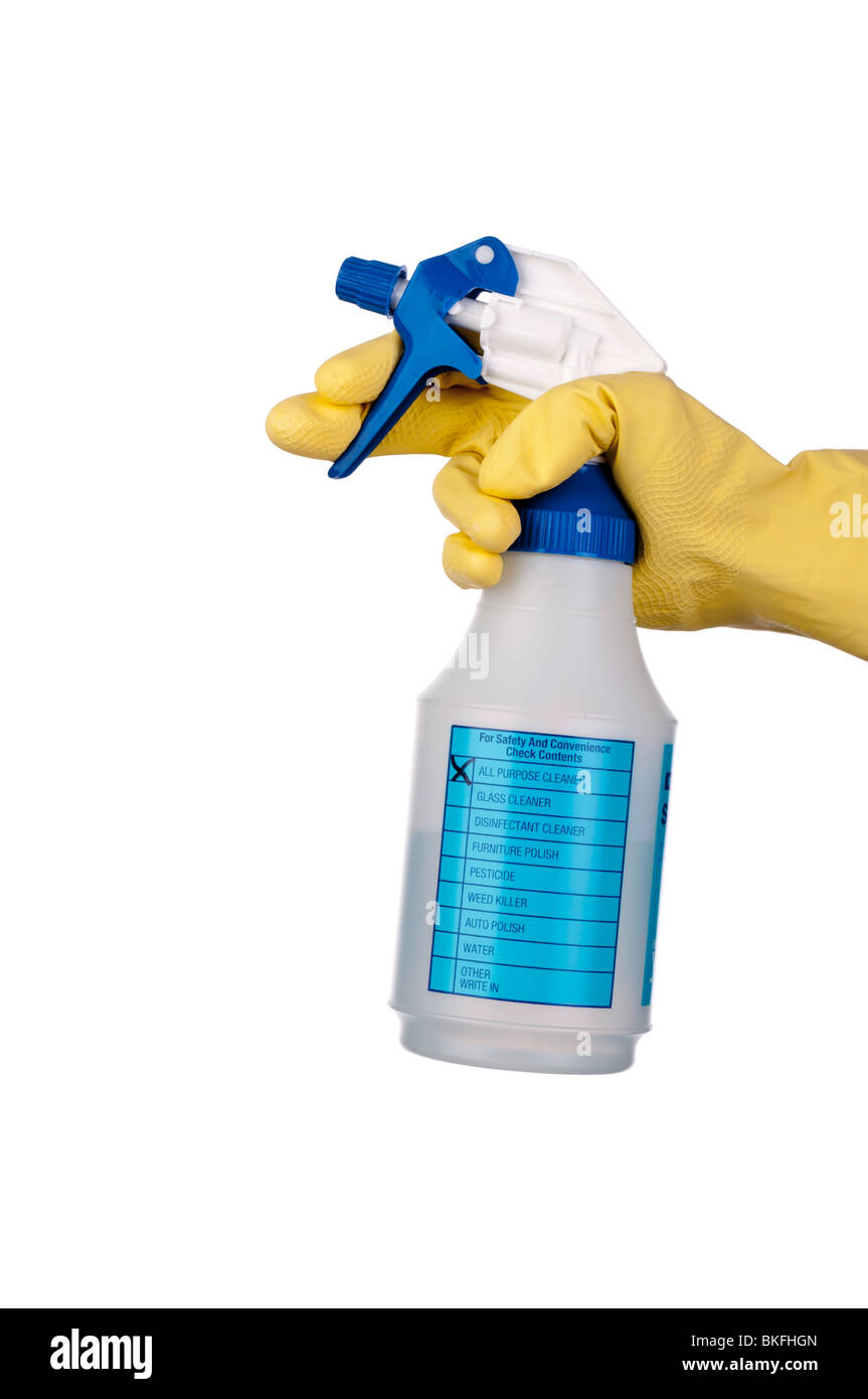 a hand in a yellow rubber glove and a cleaner sprayer Stock Photo