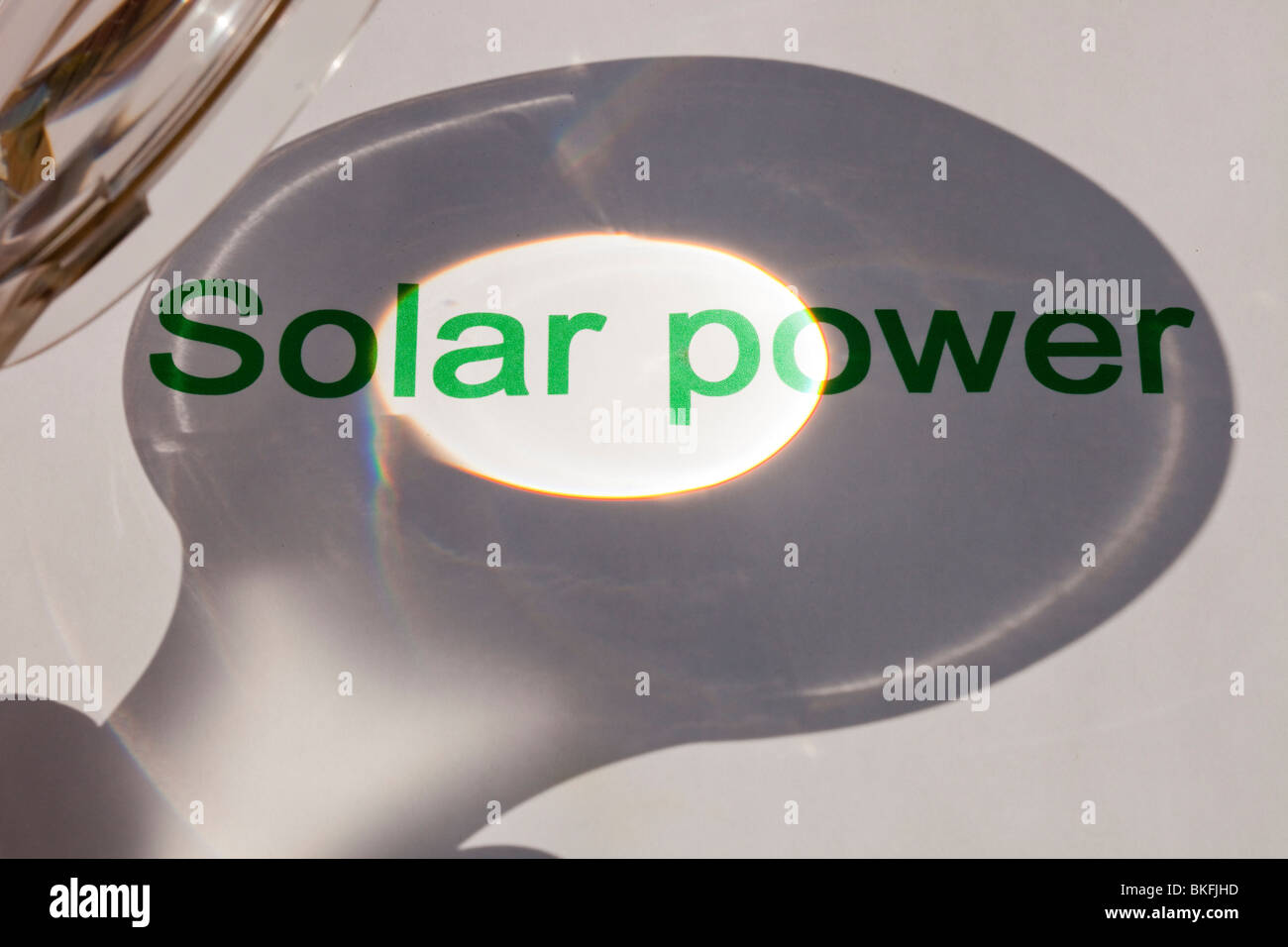 Solar power, concentrating the suns power through a magnfying glass. Stock Photo