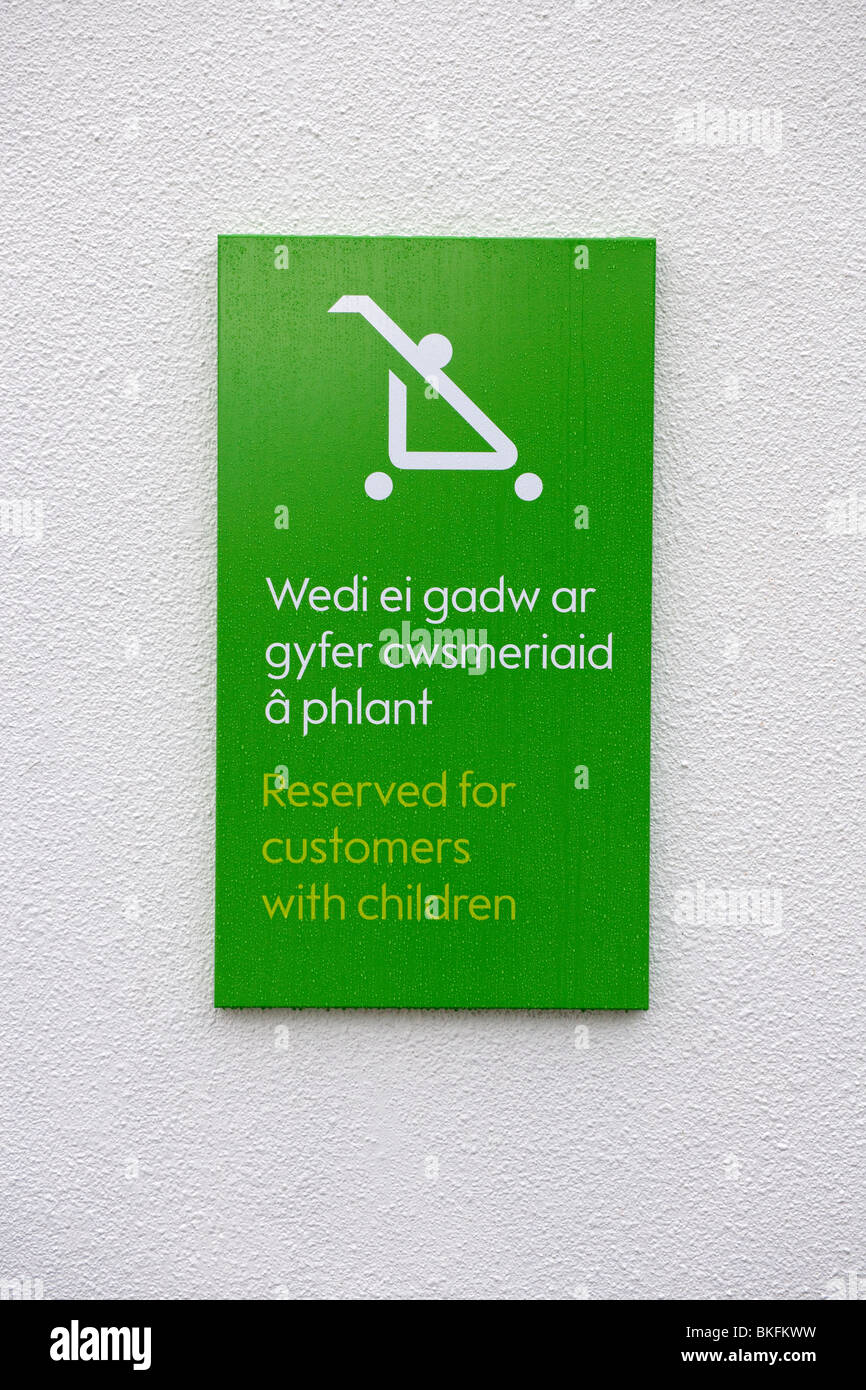 Bilingual sign (English and Welsh) on a wall outside a Waitrose store Stock Photo