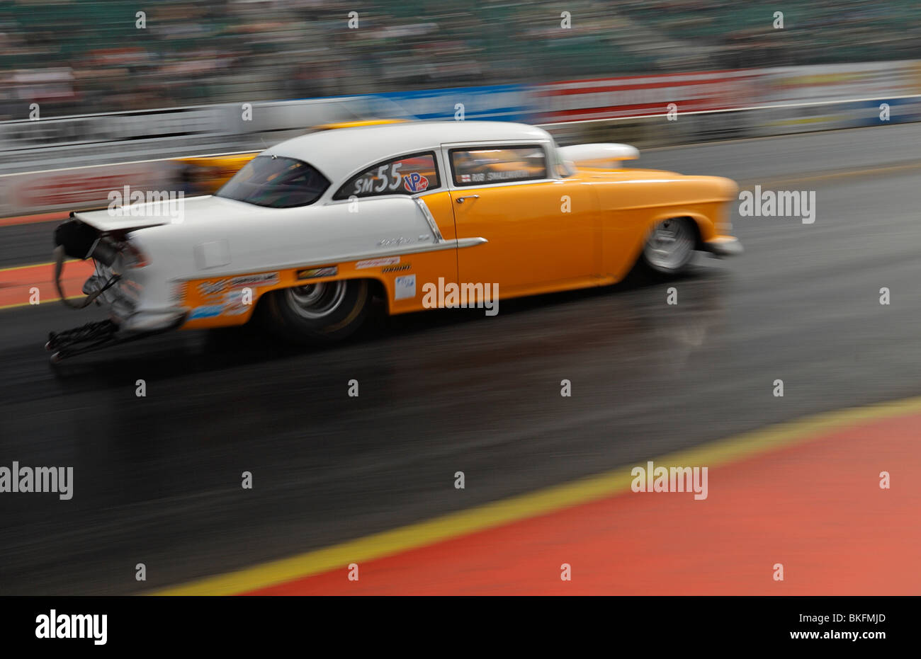 Speeding drag racing car, driven by Rob Smallworth with blur and movement. Stock Photo
