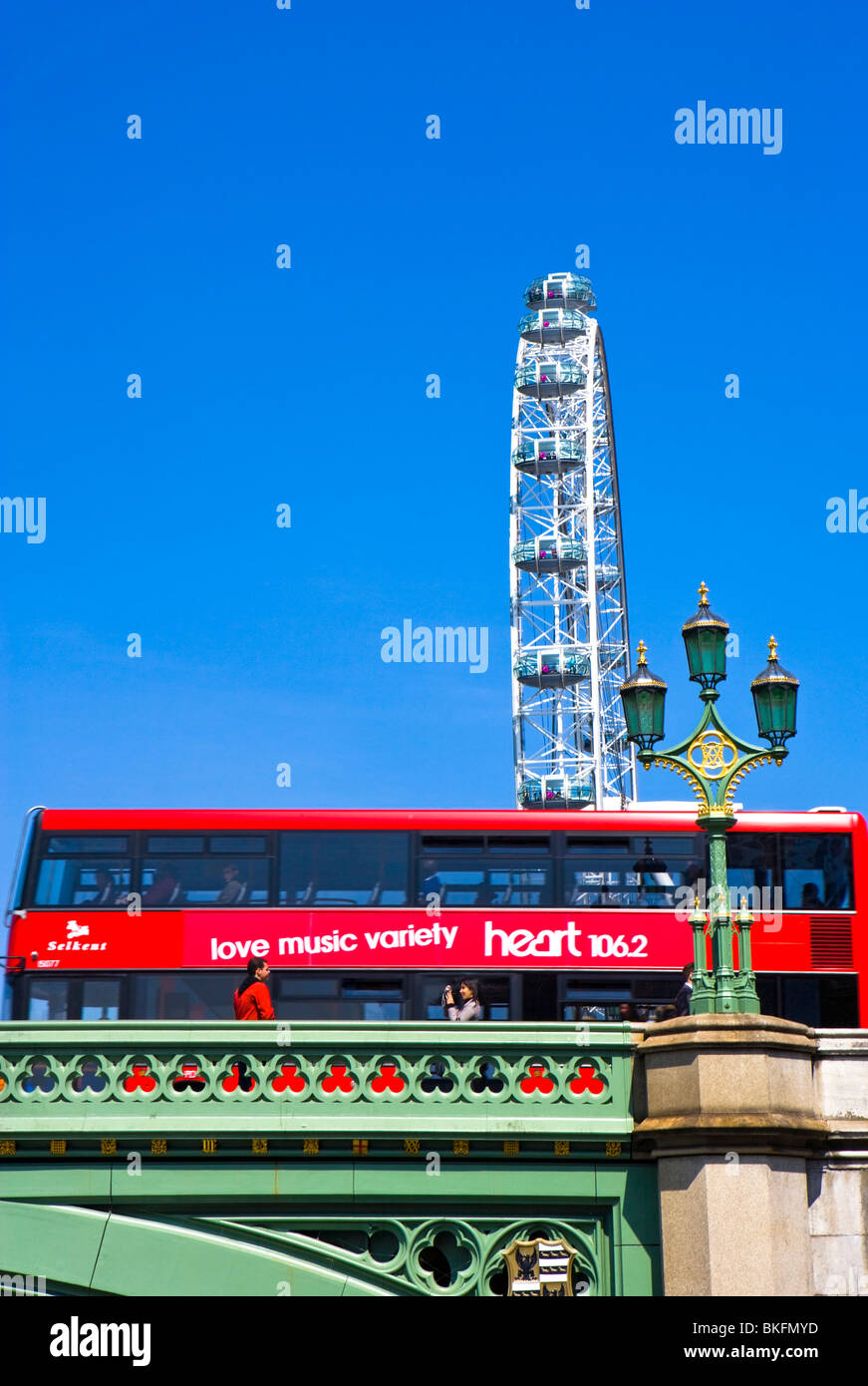 WESTMINSTER BRIDGE WITH RED BUS TOURISTS AND LONDON EYE Stock Photo