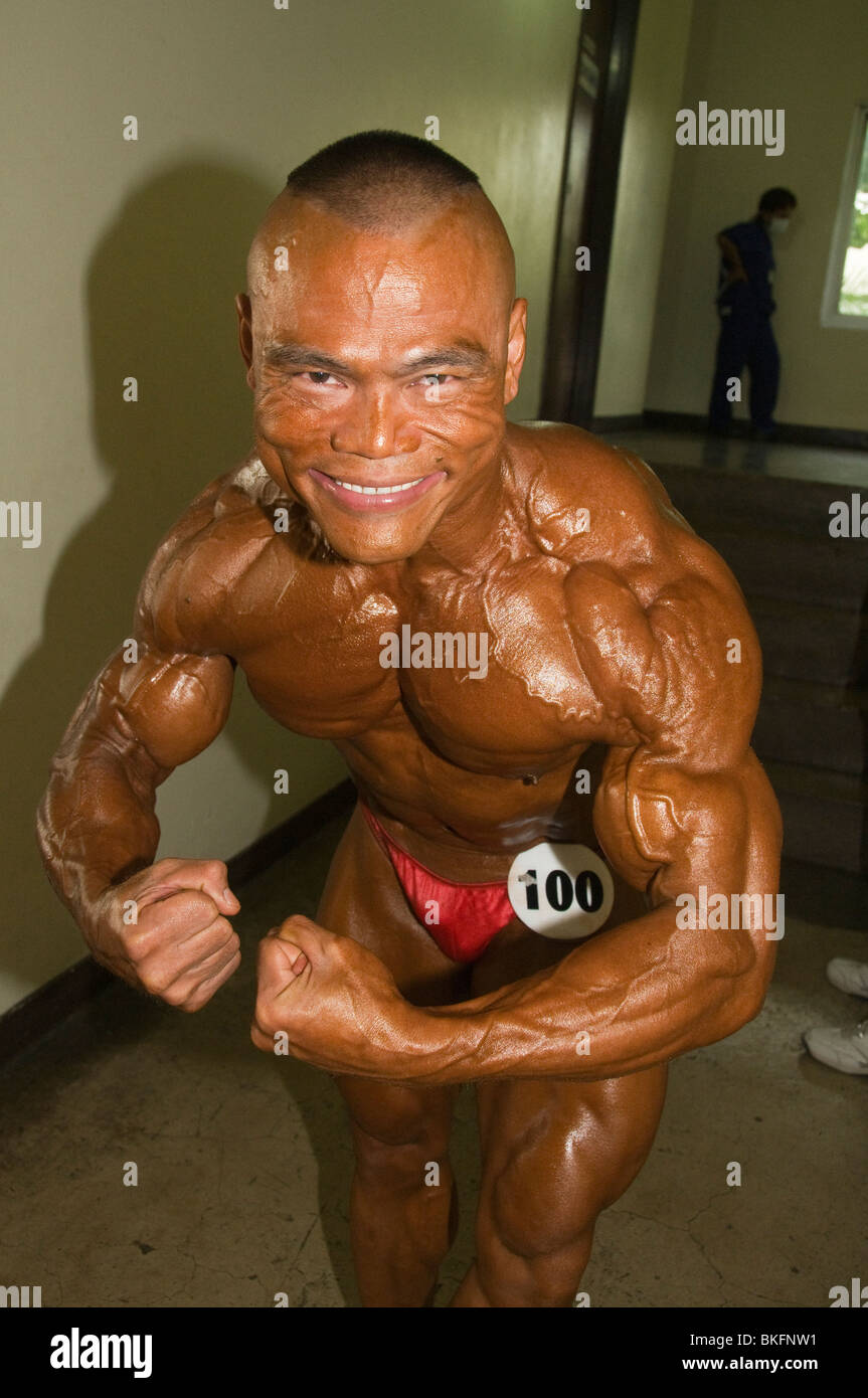 bodybuilder shows his muscles at a competition in Bangkok Thailand Stock Photo