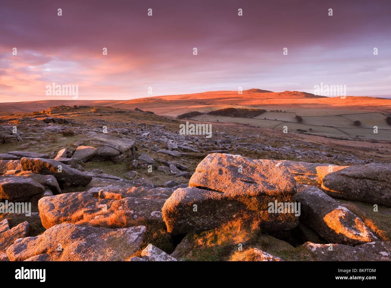 Sunrise over Belstone Tor, looking towards Yes Tor and High Willhays, the highest point in Devon and Southern Britain, Dartmoor. Stock Photo